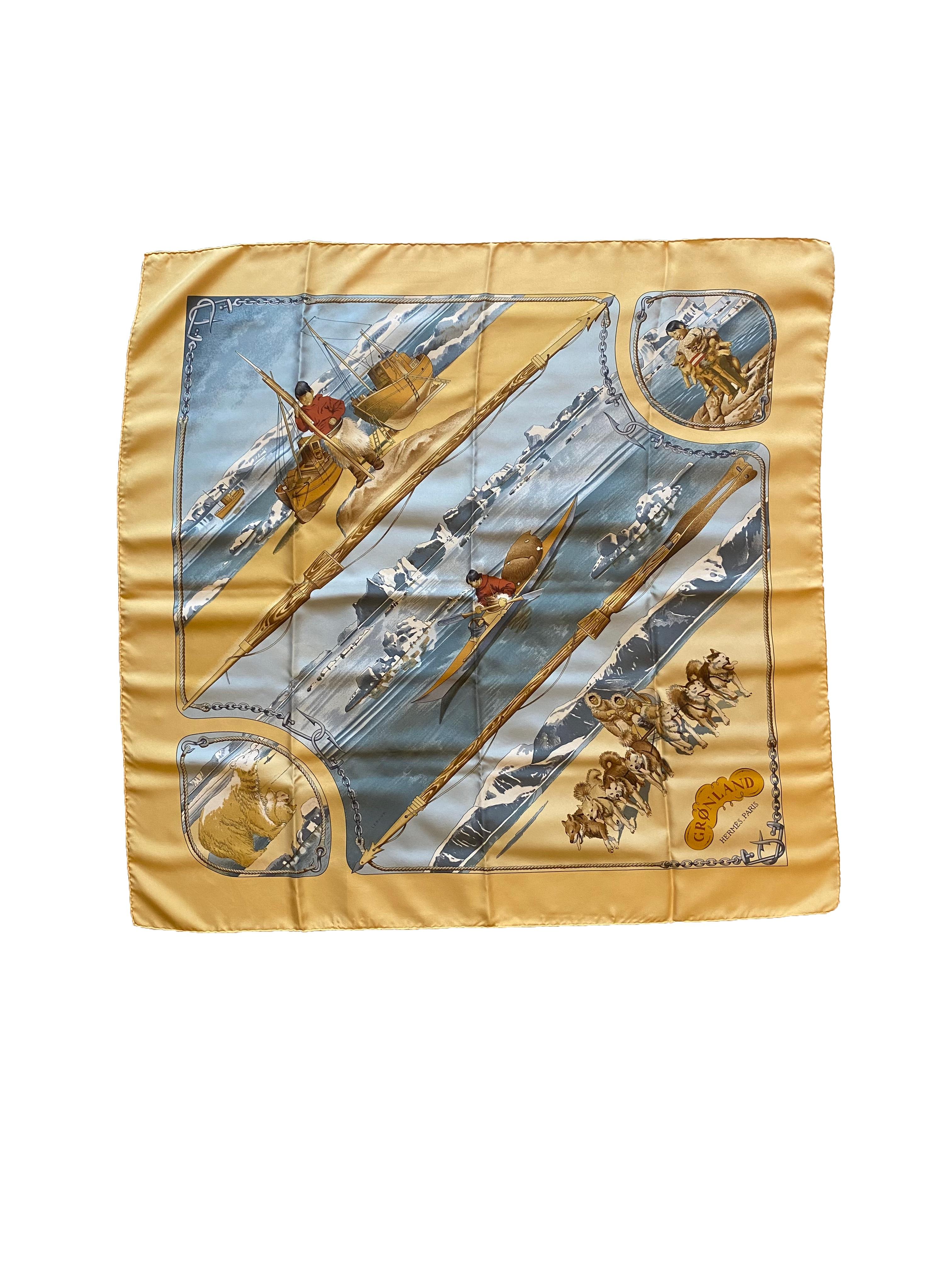 Silk scarf from Hermes. Designed by Philippe Ledoux in 1982, the 'Groenland' scarf depicts Inuit life complete with boats, huskies and polar bears. In muted, neutral tones of blue and yellow with a fishing hook border. Branded 'Hermes Paris' at the