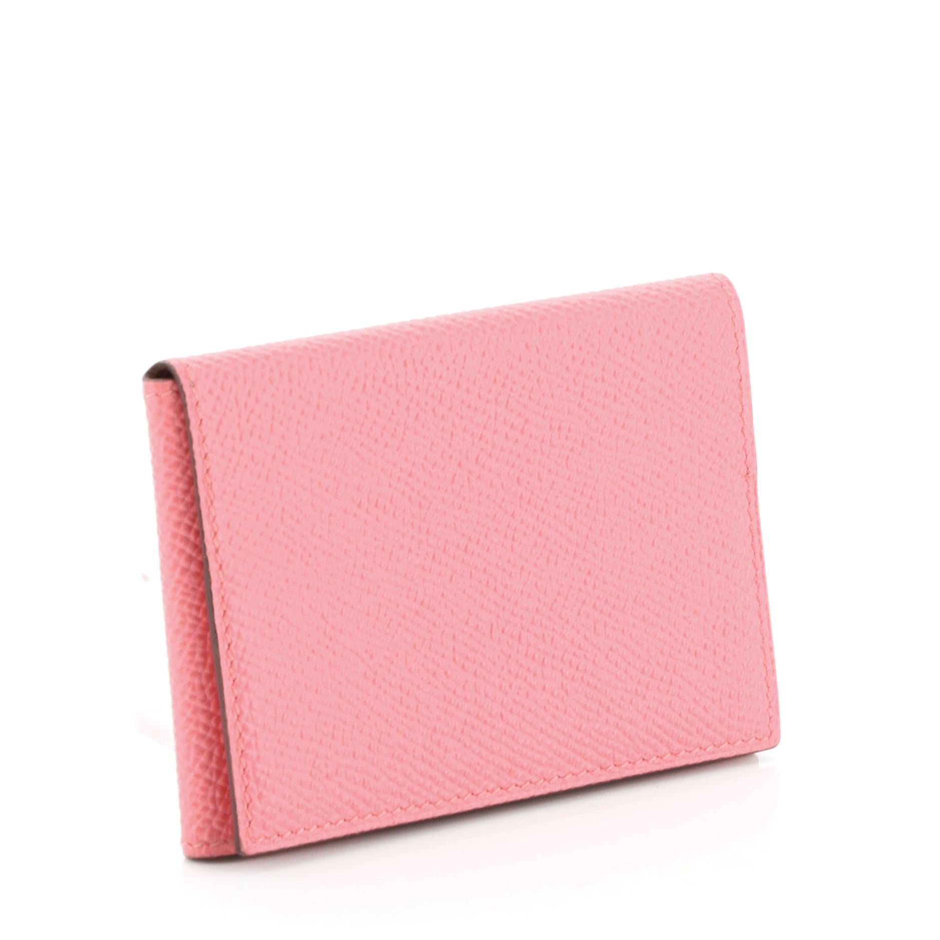 This Hermes Guernesey 3CC Card Holder Epsom, crafted from pink Epsom leather. It opens to a pink leather interior with three card slots. Date code reads: T (2015). 

Estimated Retail Price: $560
Condition: Excellent. Light wear on base wax
