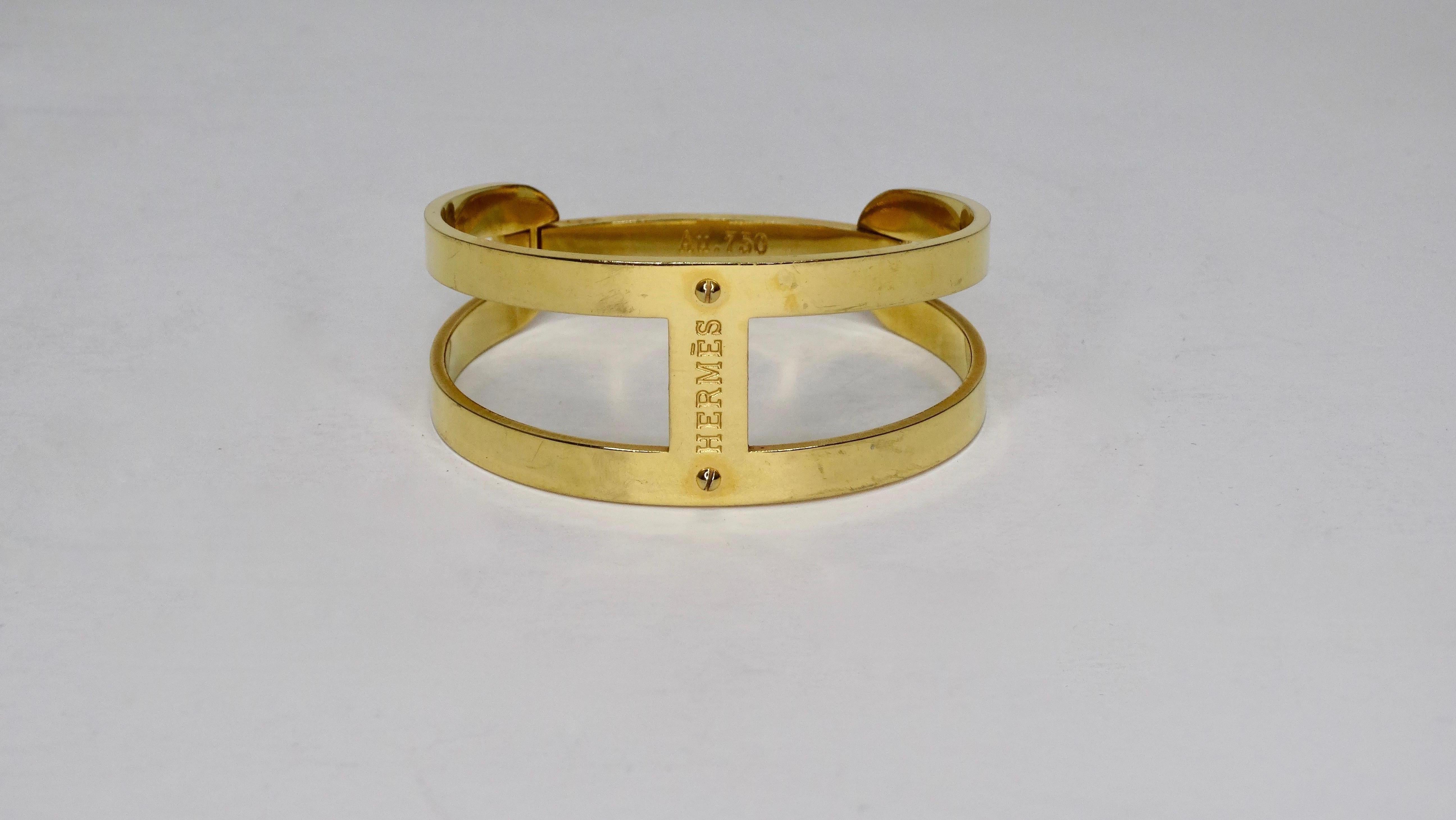 Hello Hermes! Circa 1970s, this Hermes bracelet is in 18k gold and features dual bars with Hermes stamped in the center. Includes a snap closure and is stamped Au. 750 (denoting this piece is 18k gold). Minimalistic and timeless, this Hermes