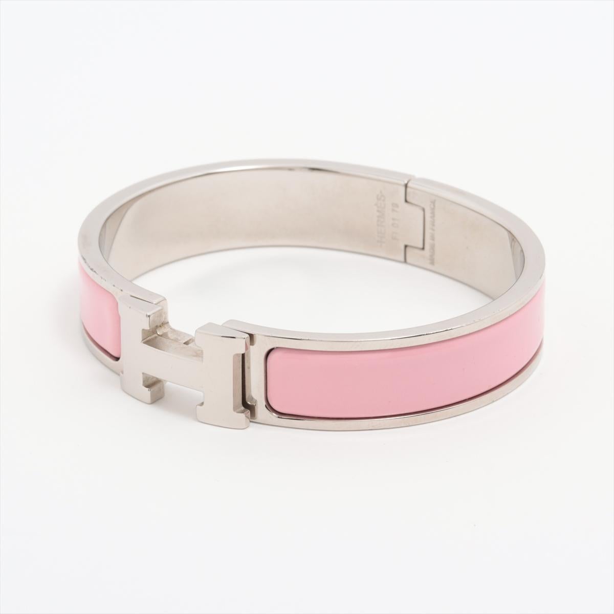 The Hermès H Bangle Clic Clac Bangle in Pink x Silver is a sophisticated and iconic accessory that exudes timeless elegance. Crafted from high-quality enamel and plated metal, the bangle features Hermès' signature H motif, making it instantly