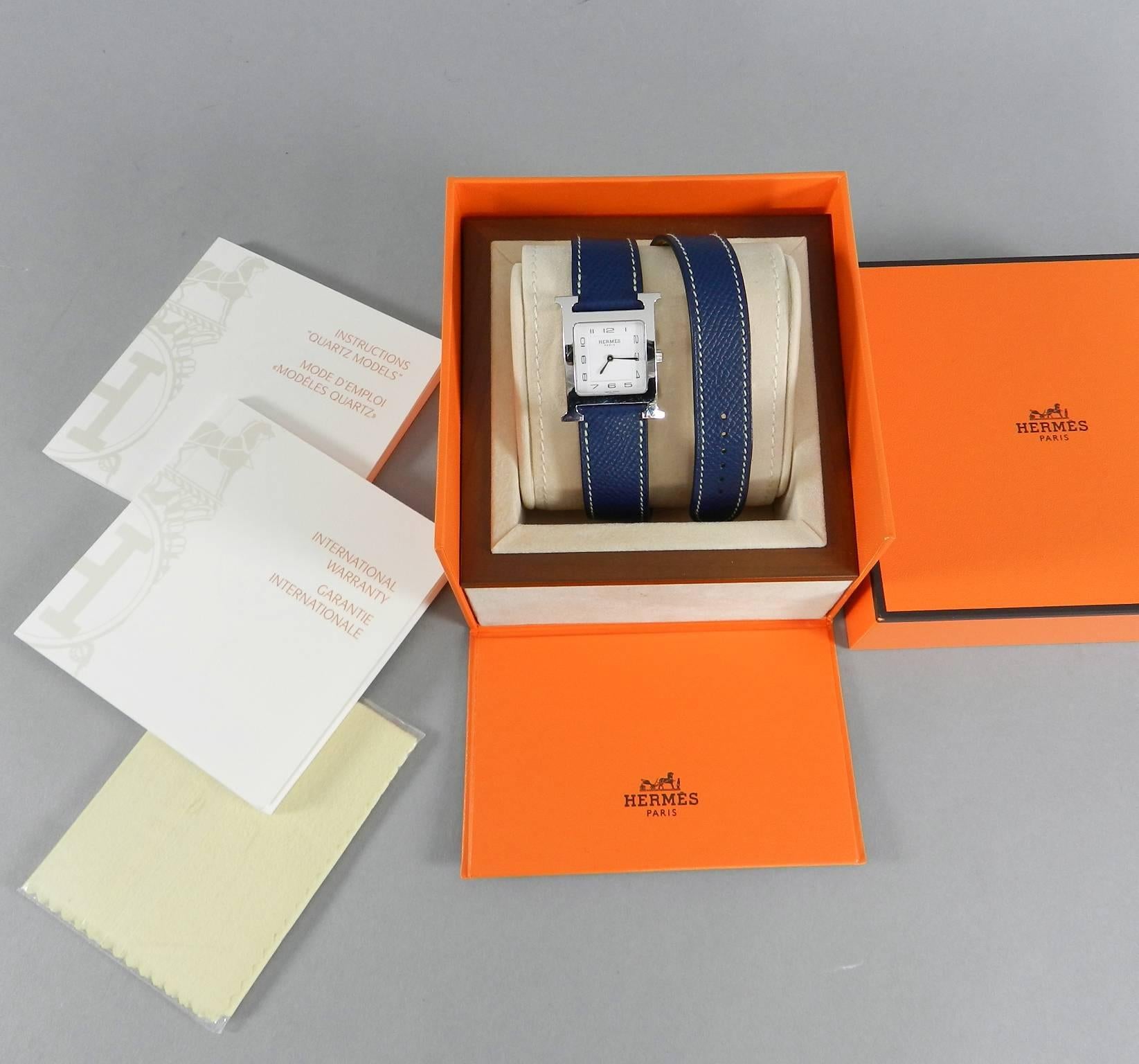 Hermes H Heure Double Tour HH1510 Medium Epsom Blue Watch.  Stainless steel H shaped case, white dial with sun pattern, quartz movement, water resistant to 3 ATM. Double wrap dark navy blue epsom leather strap.   Case size 26 x 26 mm medium size.