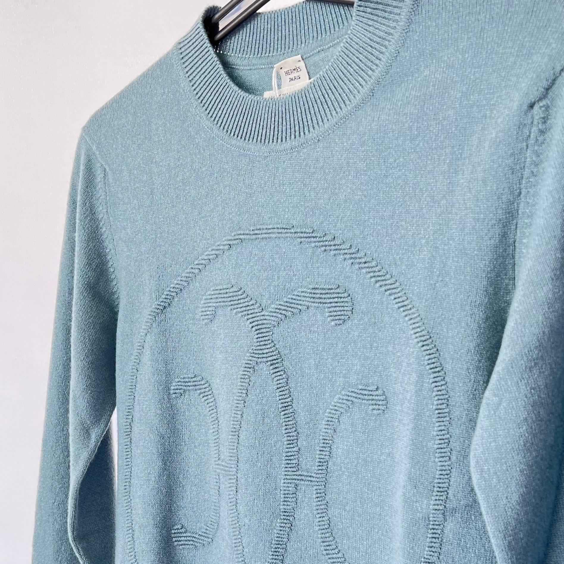 The Hermes H Lift Cashmere Sweater comes in a beautiful pale blue colour and is made from 100% cashmere. On the front of the sweater is the 'H' motif with a plain back. This item runs true to size. 

Brand: Hermès

Colour: Bleu Lichen (Light