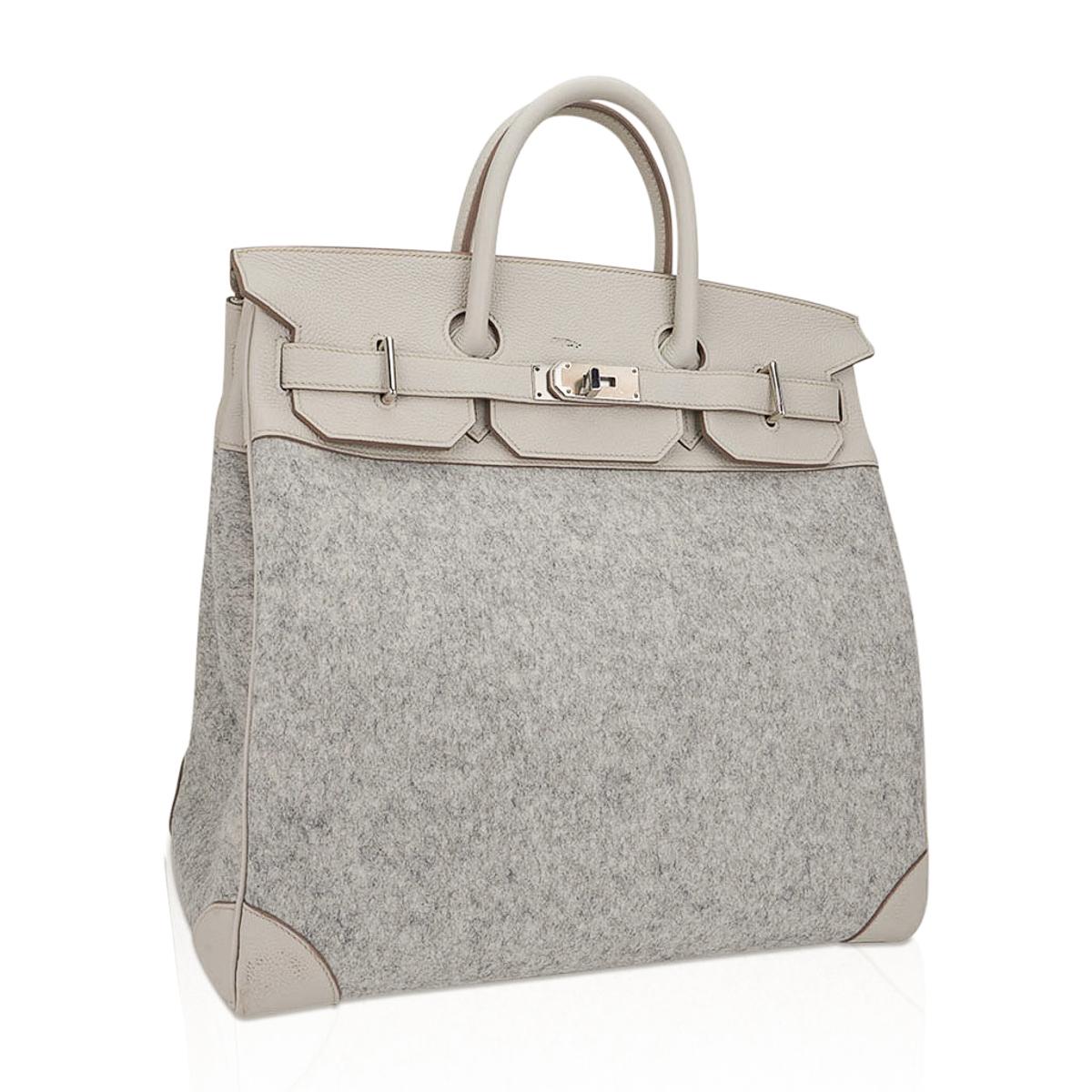 Mightychic offers a rare limited edition Hermes HAC 40 bag featured in Gris Clair Todoo Feutre (Wool) and Craie Togo leather.
A chic and masculine combination for this rare Hermes classic bag.
Beautiful light gray and Craie combination this tote bag