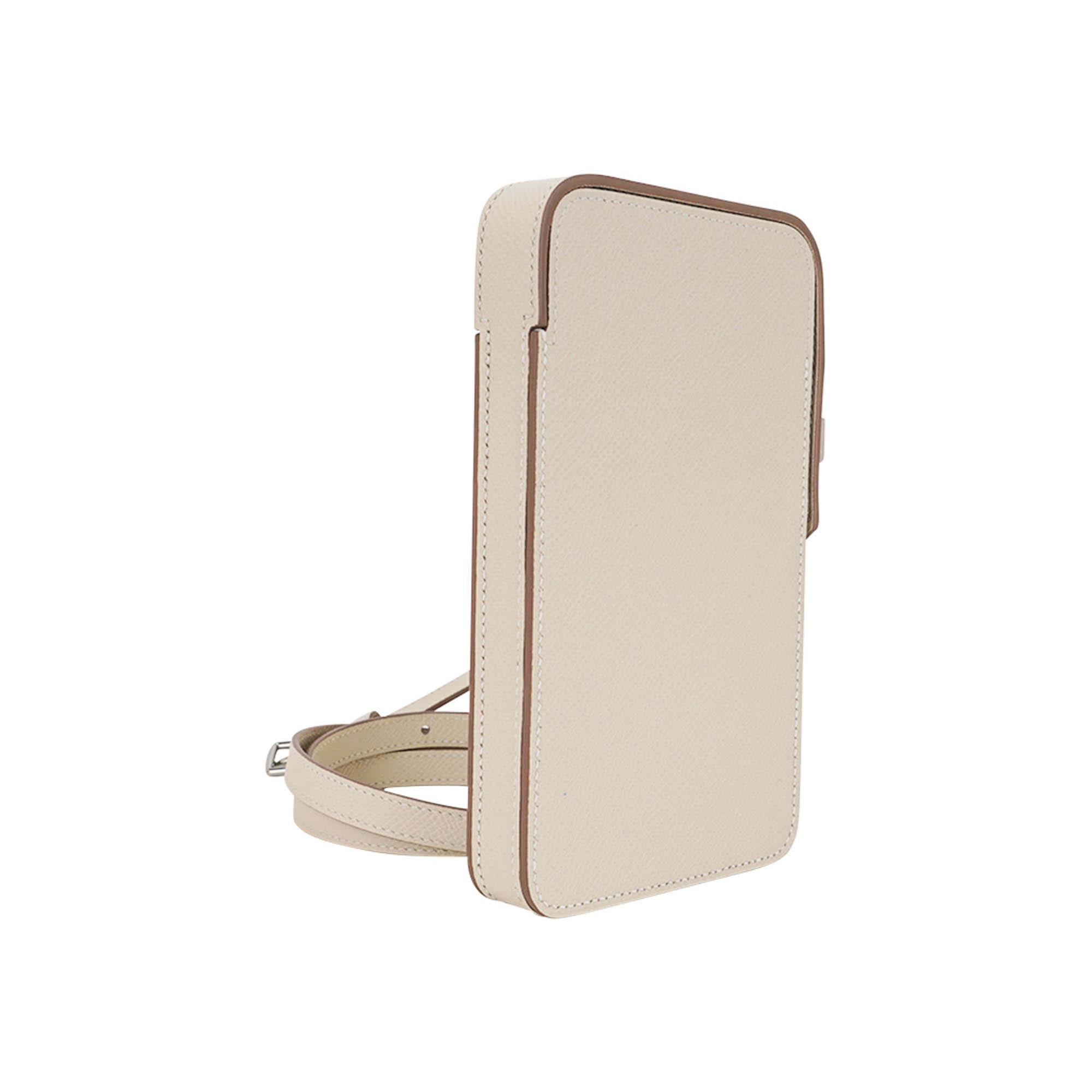 Mightychic offers a limited edition Hermes Hac a Box Phone Case featured in Craie Epsom leather.
Crisp with Palladium hardware.
This very rare to find versatile case with adjustable strap can be carried on the shoulder or as crossbody.
With