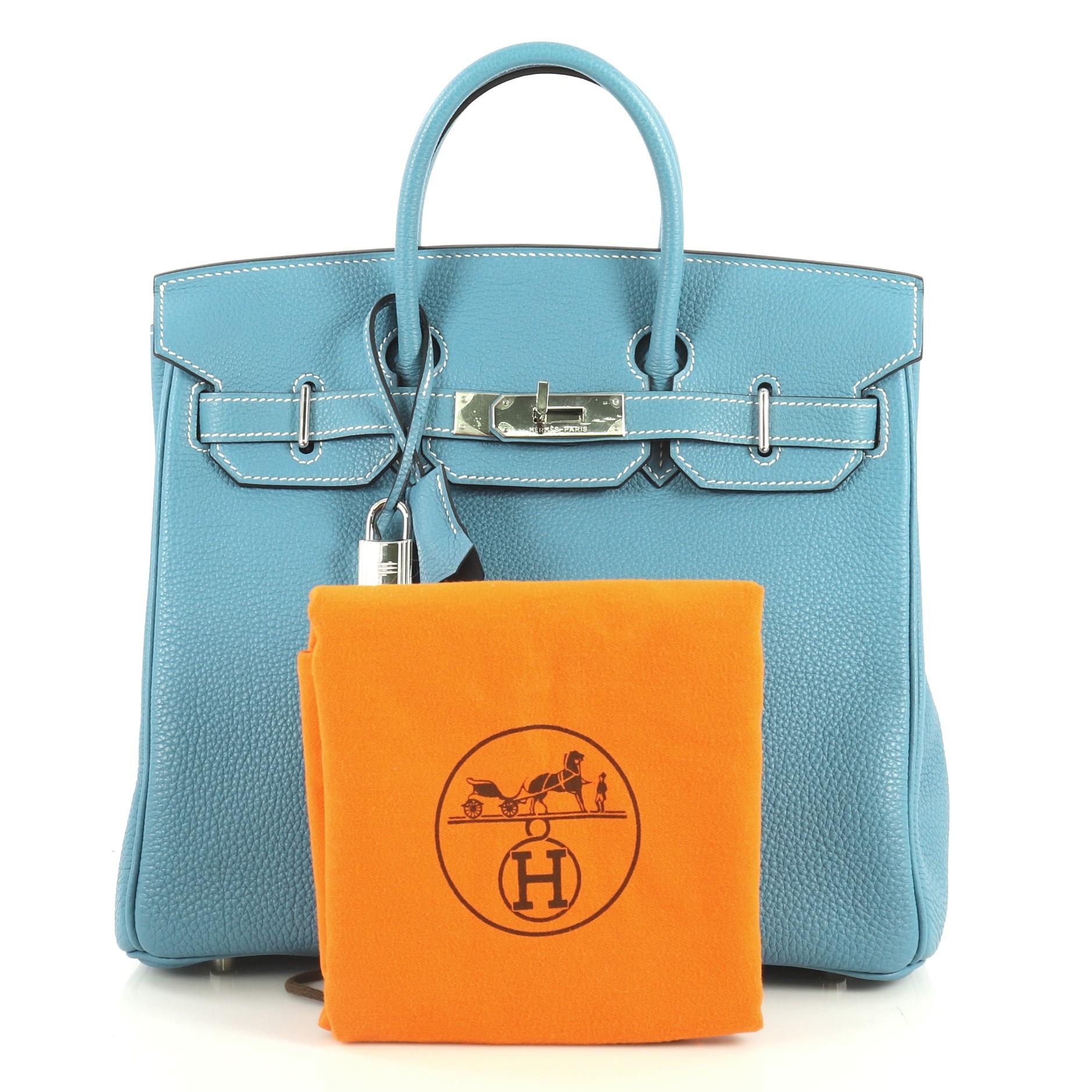 This Hermes HAC Birkin Bag Bleu Jean Togo with Palladium Hardware 28, crafted in Bleu Jean blue Togo leather, features dual rolled handles, front flap, and palladium hardware. Its turn-lock closure opens to a Bleu Jean blue Chevre leather interior