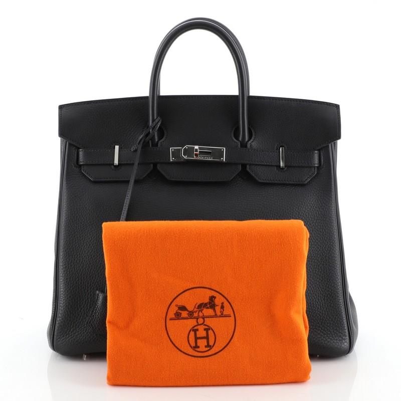 This Hermes HAC Birkin Bag Noir Clemence with Palladium Hardware 32, crafted in Noir black Clemence leather, features dual rolled handles, front flap, and palladium hardware. Its turn-lock closure opens to a Noir black Chevre leather interior with