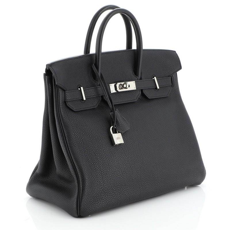 This Hermes HAC Birkin Bag Noir Togo with Palladium Hardware 32, crafted in Noir black Togo leather, features dual rolled handles, front flap, and palladium hardware. Its turn-lock closure opens to a Noir black Chevre leather interior with zi[ and