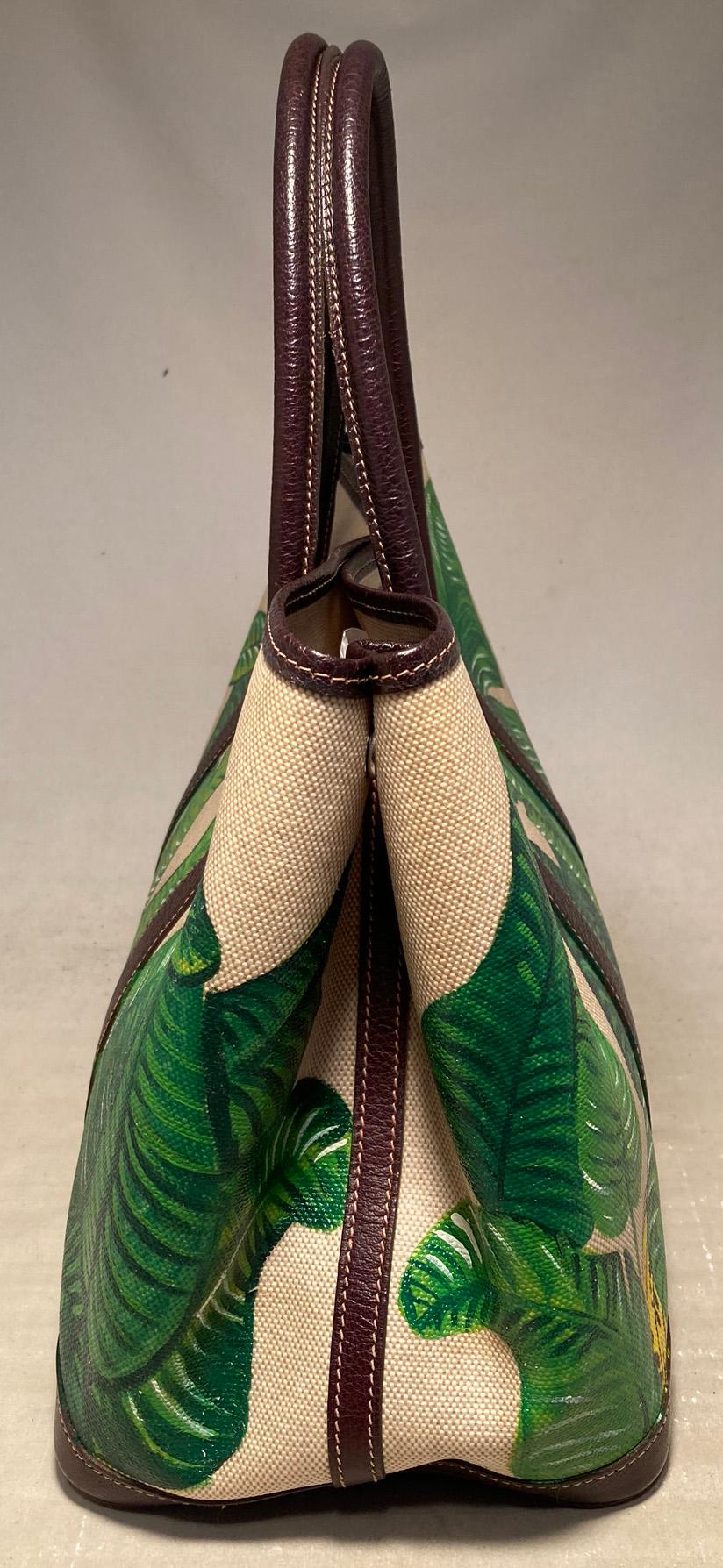 Hermes Hand Painted Banana Leaf Garden Party 35 in excellent condition. Signature woven beige canvas with dark brown leather handles, trim, and base. Hand painted green banana leaves painted on the surrounding beige canvas exterior. Top snap closure