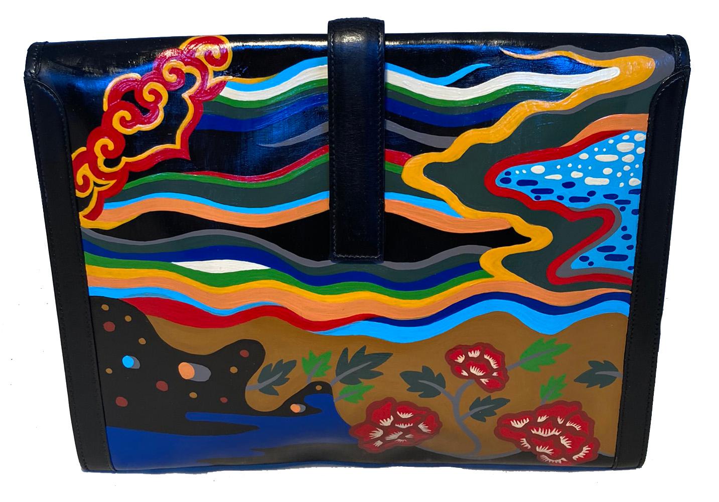 Hermes Hand Painted Jige Clutch in very good condition. Black box calf leather exterior in classic jige clutch shape with colorful abstract hand painted design throughout. Front strap flap closure opens to a woven beige canvas lined interior. Clean