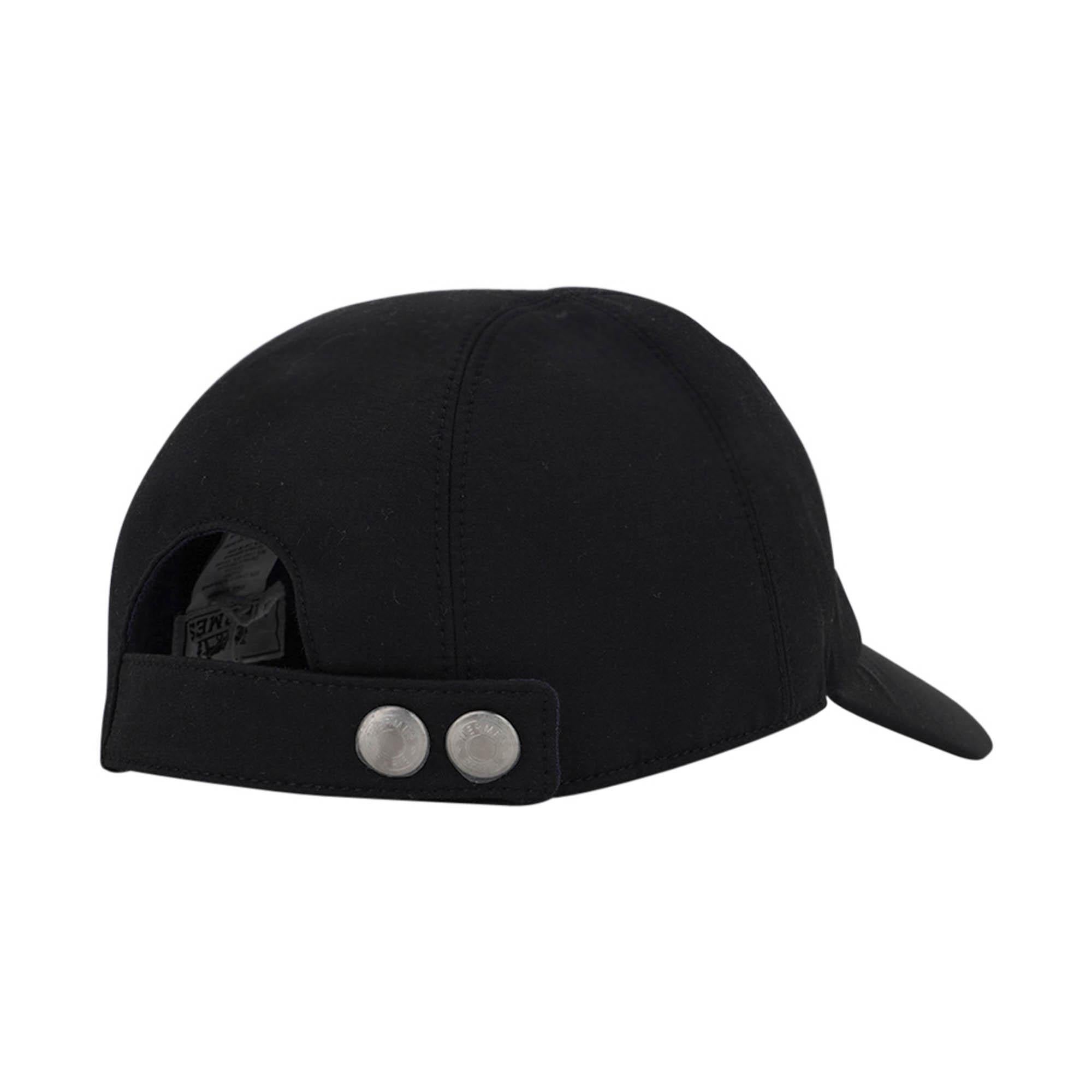 Mightychic offers an Hermes Miles Robot cap featured in Black. 
Swift leather Clou de Selle not stamped on the side in Bleu Encre. 
Brushed palladium Clou de selles snaps at rear. 
Lined in blue.
Water resistant technical gabardine.
Visor length is