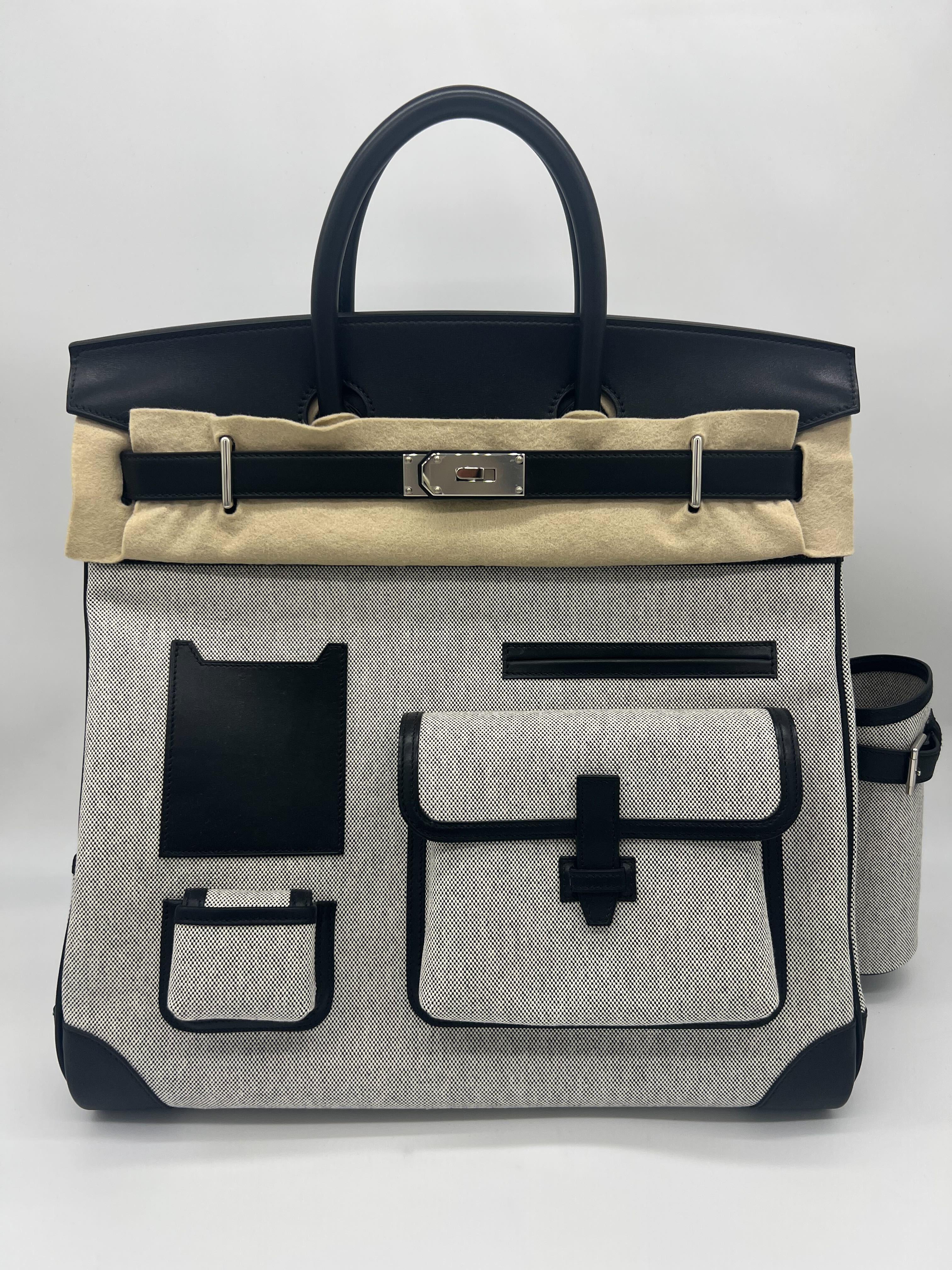 Hermes Birkin 40 Haut A Courroies 40 Cargo Bag AA Ecru-Noir/Noir
 
Condition: Brand New 
Material: Evercalf leather and Toile H
Measurements: 40 x 40 x 23cm
Hardware: Palladium
 
Comes with full original packaging. 
Includes original Hermes