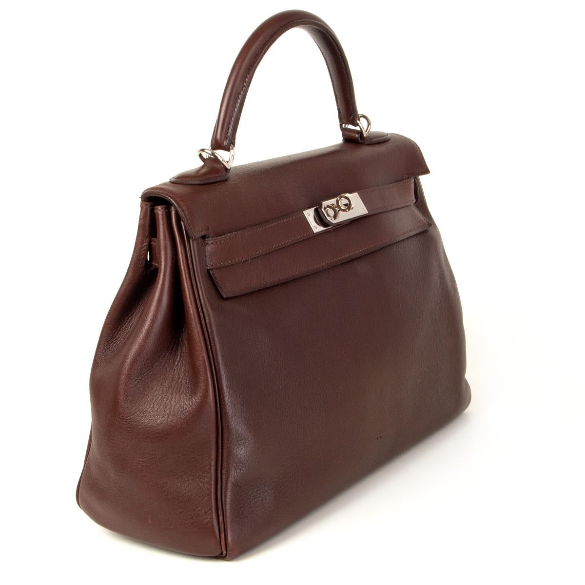 100% authentic Hermès Kelly II 32 Retourne bag in Havane brown soft swift leather with palladium hardware. Lined in Chevre (goat skin) with an open pocket against the front and a zipper pocket against the back. Has been carried and shows some wear