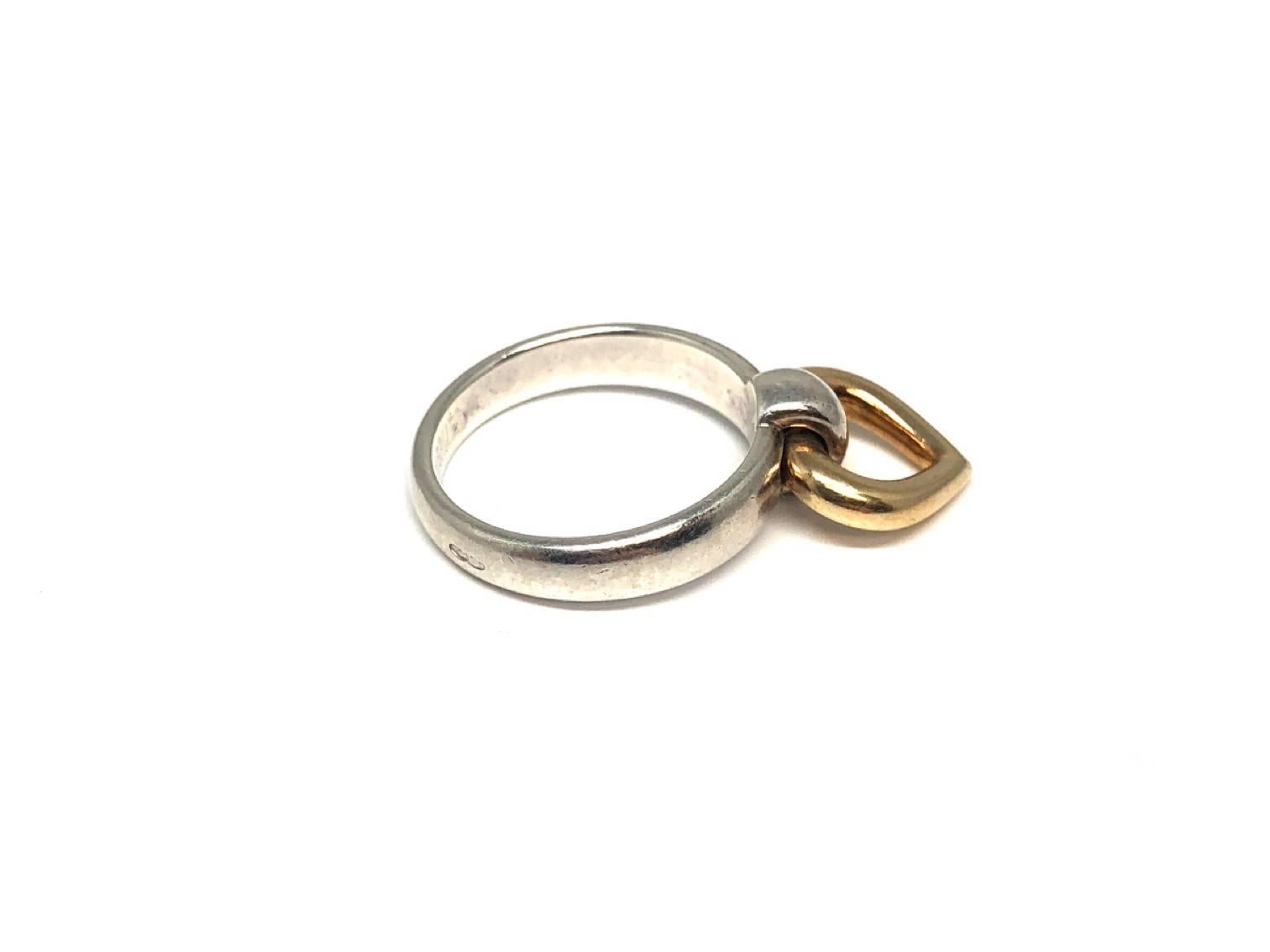 Classic Hermes design with a silver band and a moving heart of gold on the top of the band. Very stylish and simplistic ring which is perfect for everyday. 