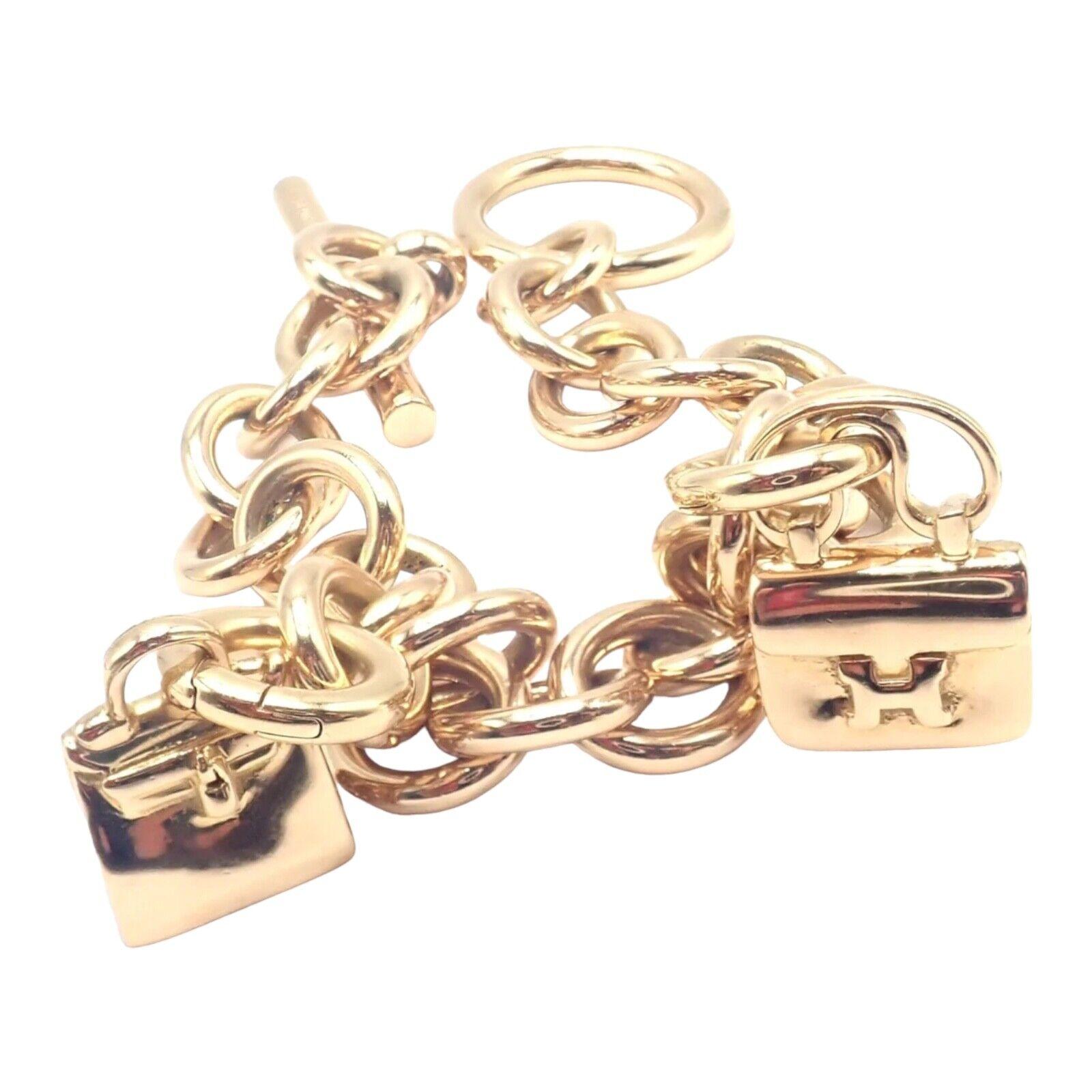 18k Yellow Gold 2 Hanging Bag Charms Link Bracelet by Hermes. 
Includes a total of 2 Hermes bag charms: 
With Kelly bag 22x12mm
Constance bag 25x14mm
Both charms are detachable
The Authentic! Hermes 18k Yellow Gold Heavy Link Toggle With Two Charms