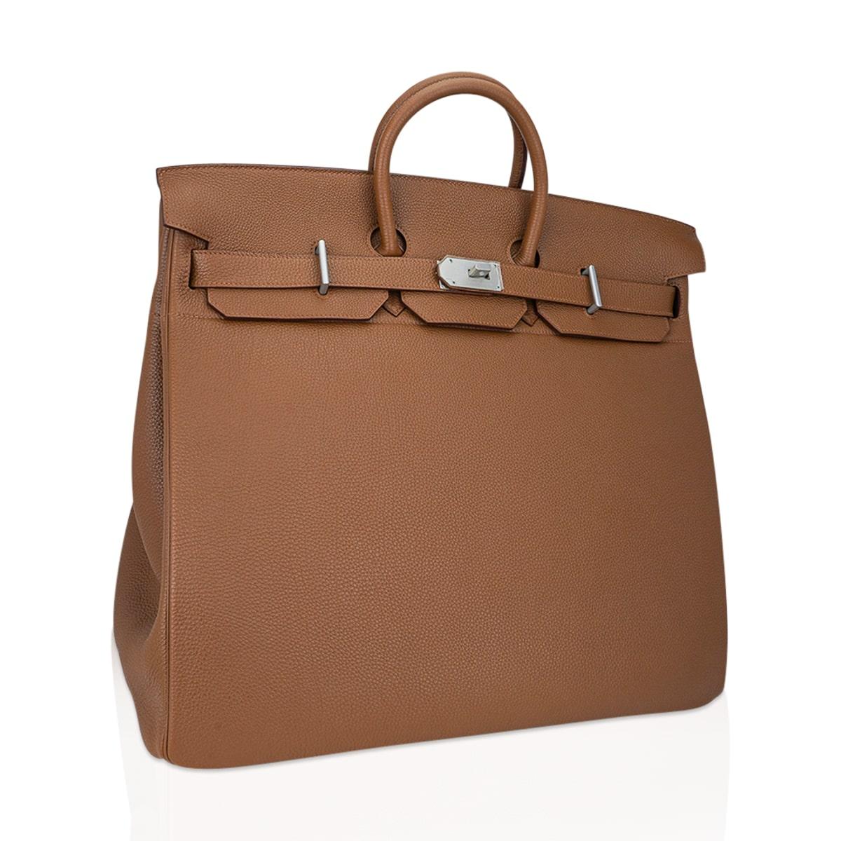 Guaranteed authentic rare Hermes Helium 50 HAC bag (Haut a Courroies) featured in Alezan togo leather.  
Limited edition accentuated with Aluminum hardware.  
Chic and timeless.   
This beautiful travel bag is a true Hermes collectors treasure - and