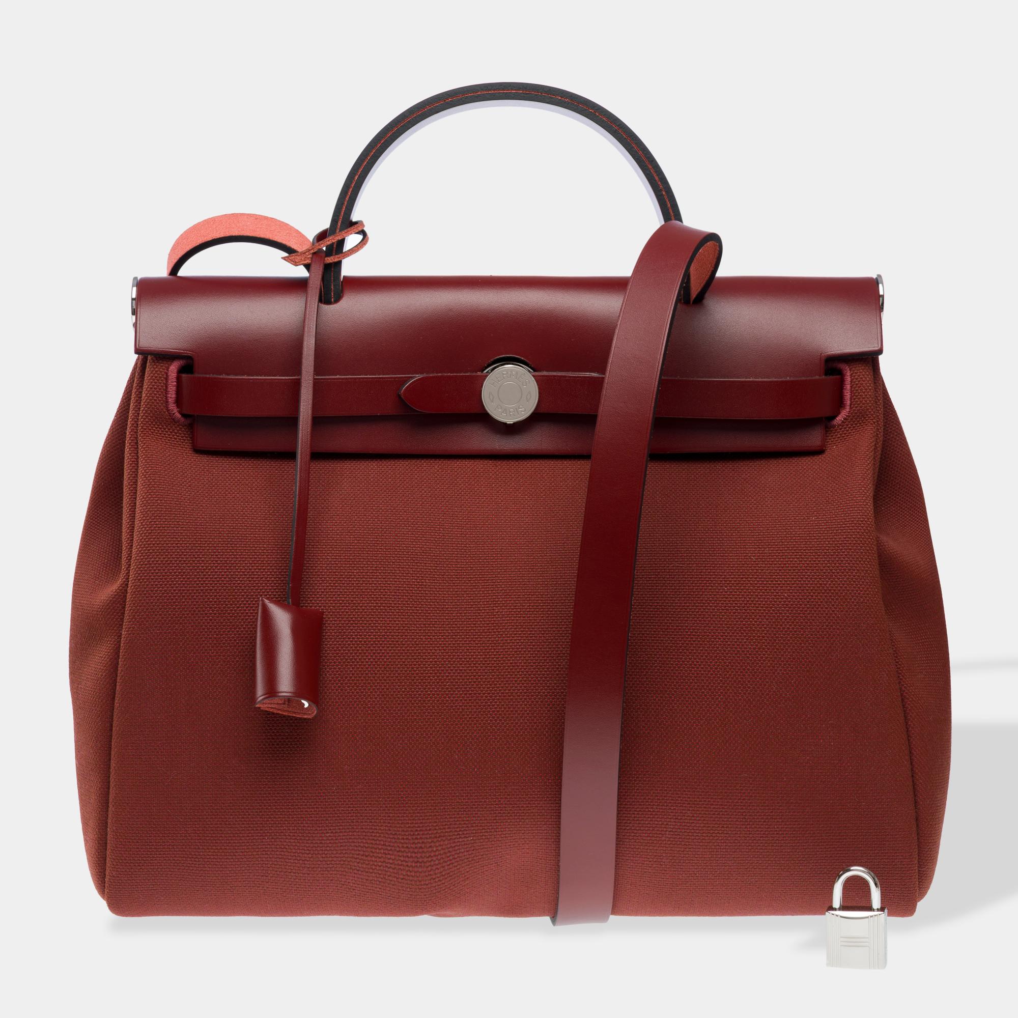 Very​ ​beautiful​ ​bag​ ​Hermès​ ​Herbag​ ​zip​ ​31​ ​in​ ​Red​ ​H​ ​canvas​ ​officer​ ​and​ ​Red​ ​H​ ​calf​ ​Hunter​ ​leather,​ ​palladium​ ​metal​ ​trim,​ ​red​ ​leather​ ​handle,​ ​a​ ​red​ ​leather​ ​handle​ ​allowing​ ​a​ ​hand​ ​or​