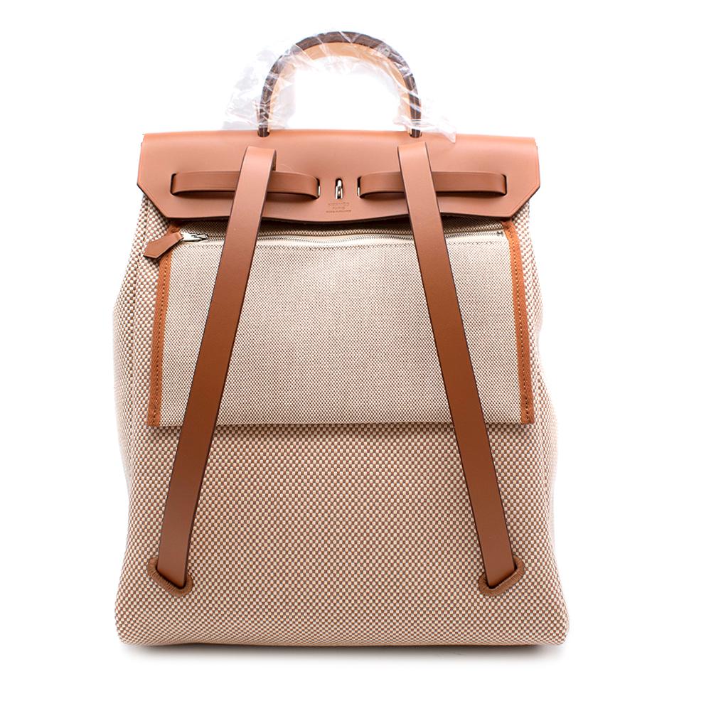 Hermès HerBag A Dos Zip Retourné Backpack in Criss Viking Canvas and Hunter Cowhide with Shoulder Straps, Top Handle Outside Pocket and Palladium Plated Clou de Selle Closure. 
2019

Includes Box and Dust Bag. 
Size: OS

L 29 x H 38 x D 11 cm
