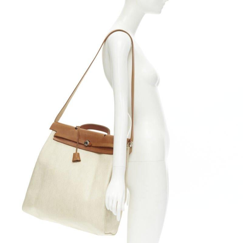 HERMES Herbag MM beige Toile coated canvas brown leather PHW 2-in-1 bag
Reference: AEMA/A00102
Brand: Hermes
Model: Herbag
Material: Leather, Canvas
Color: Beige, Brown
Pattern: Solid
Closure: Loop Through
Lining:  Leather
Extra Details: Beige
