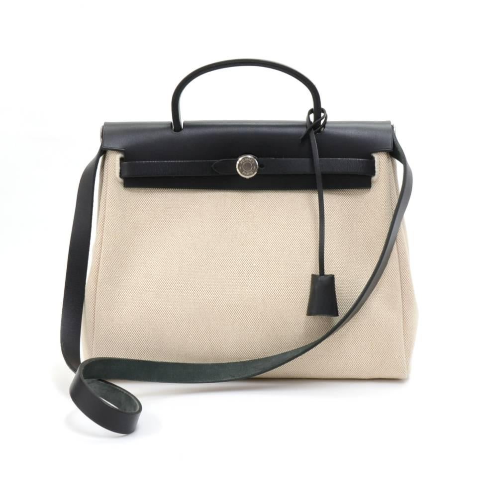 Hermes HerBag PM  2 in 1. Two canvas bags with leather. Leather pieces can be attached to either the beige or black canvas bags so you can enjoy 2 different looks. The bag can be carried on the shoulder  with the removale strap or in the hand. Very