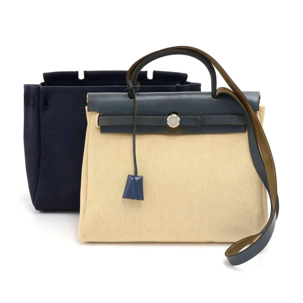 Hermes HerBag PM  2 in 1. Two canvas bags with leather top flap and strap. Leather pieces can be attached to either the beige or blue canvas bags so you can enjoy 2 different looks. The bag can be carried on the shoulder with the removable strap or