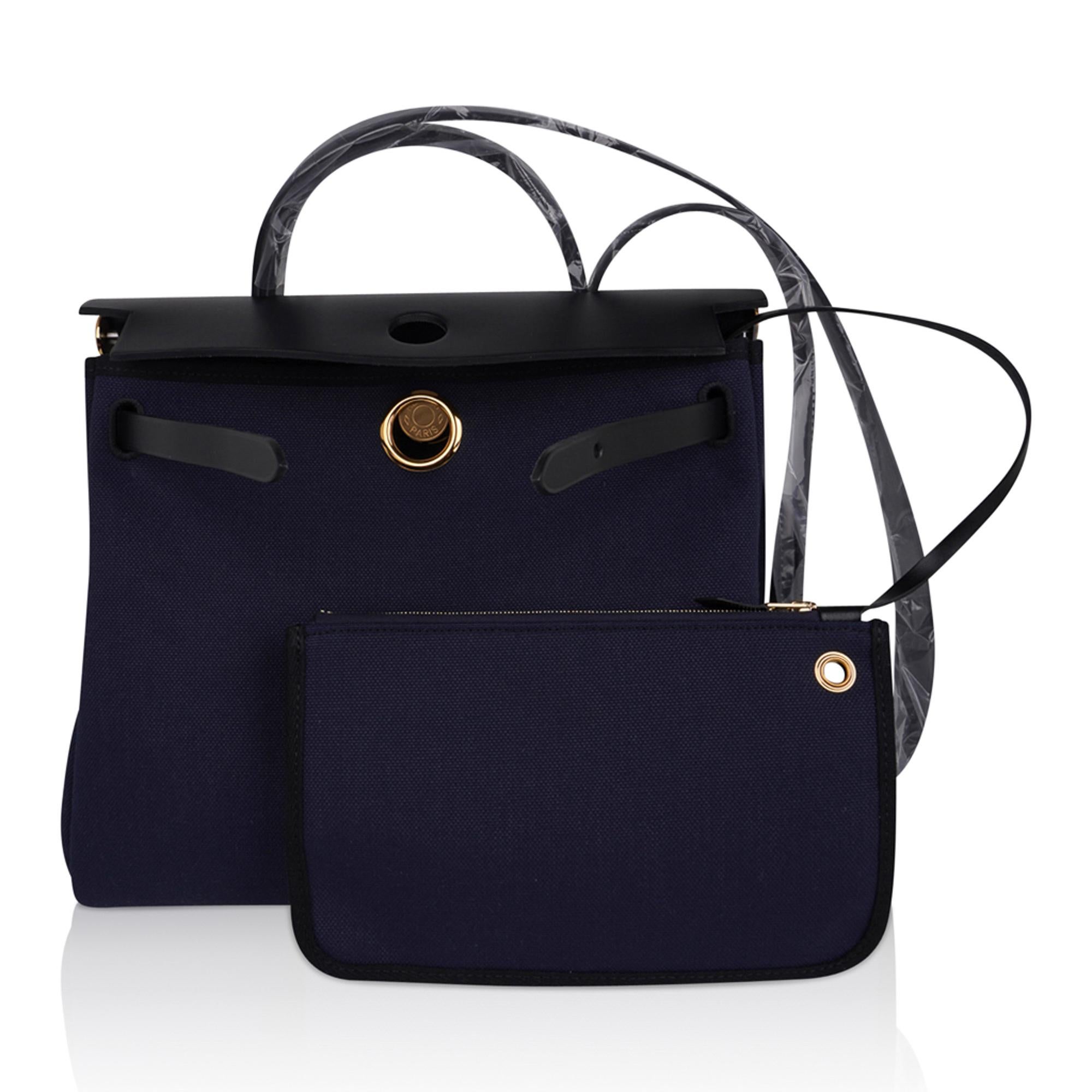 Mightychic offers an Hermes Herbag Zip 31 featured in Bleu Indigo Toile and Black Vache Hunter cowhide leather.
Rare with Gold signature Clou de Selle closure.
Chic colour combination and a fabulous versatile bag. 
Rear has an exterior canvas zip