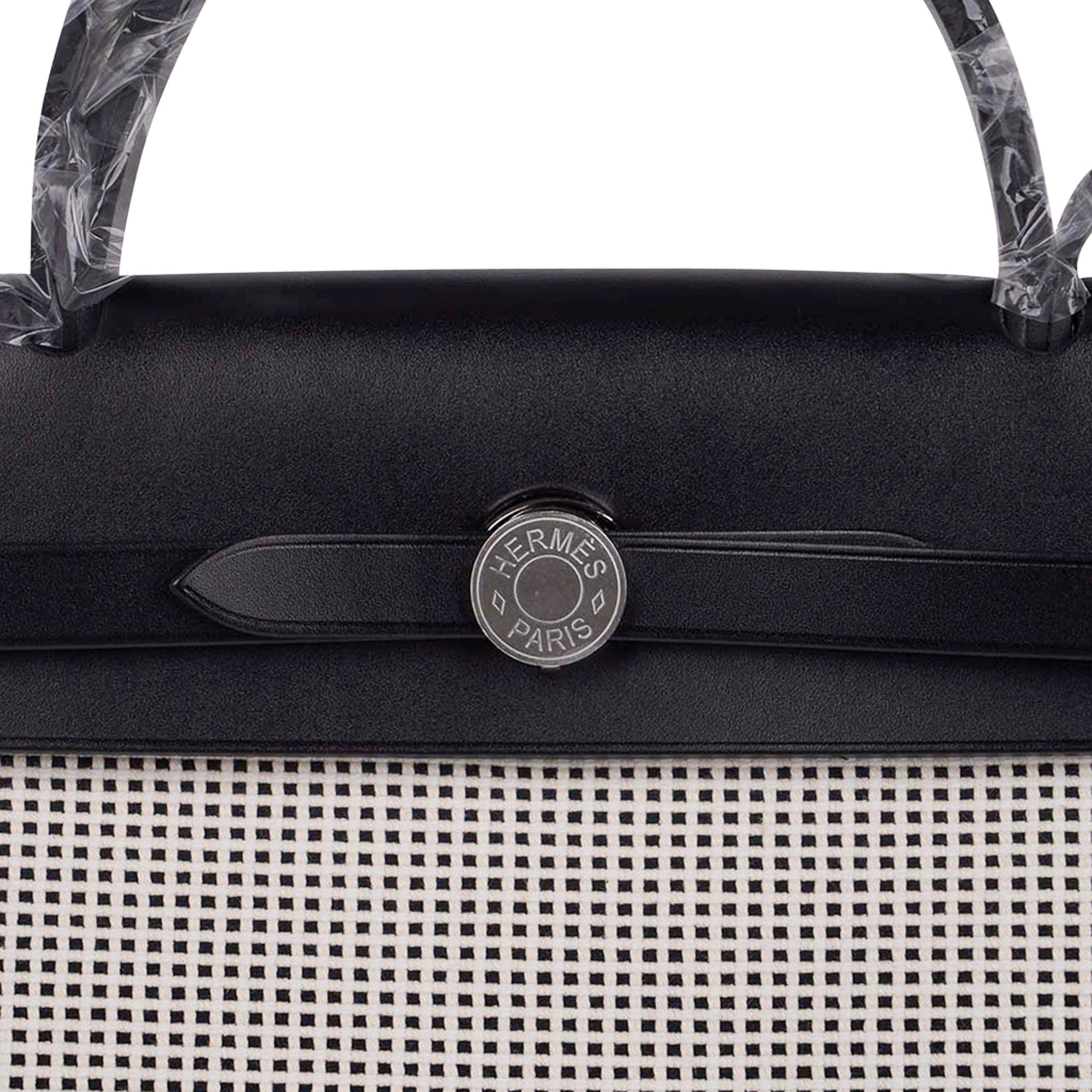 Mightychic bietet ein Viking Criss Toile  Hermes Herbag Zip 31 in knackigem Schwarz und Weiß.
Akzentuiert mit schwarzem Vache Hunter-Rindsleder.
Palladium-Signatur Clou de Selle-Verschluss.
Auf der Rückseite befindet sich eine Reißverschlusstasche