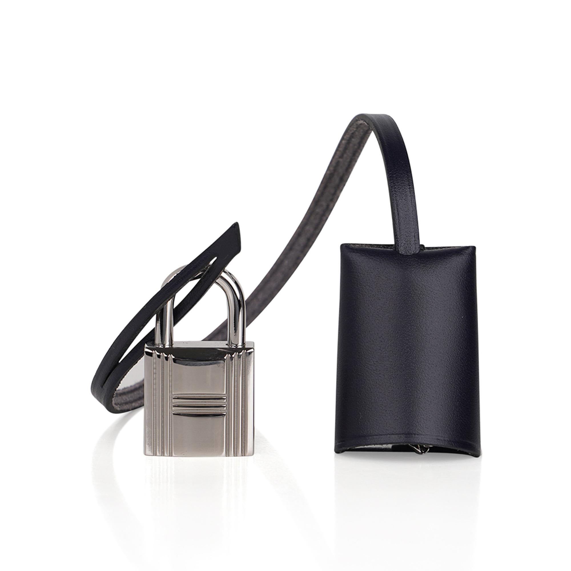 Mightychic offers a guaranteed authentic  Hermes Herbag Zip 31 featured in Black Toile and Blue Indigo Vache Hunter leather.
Blue Indigo top with Black straps.
Chic rich combination!
Signature Herbag Clou de Selle Palladium hardware.
Has a matching