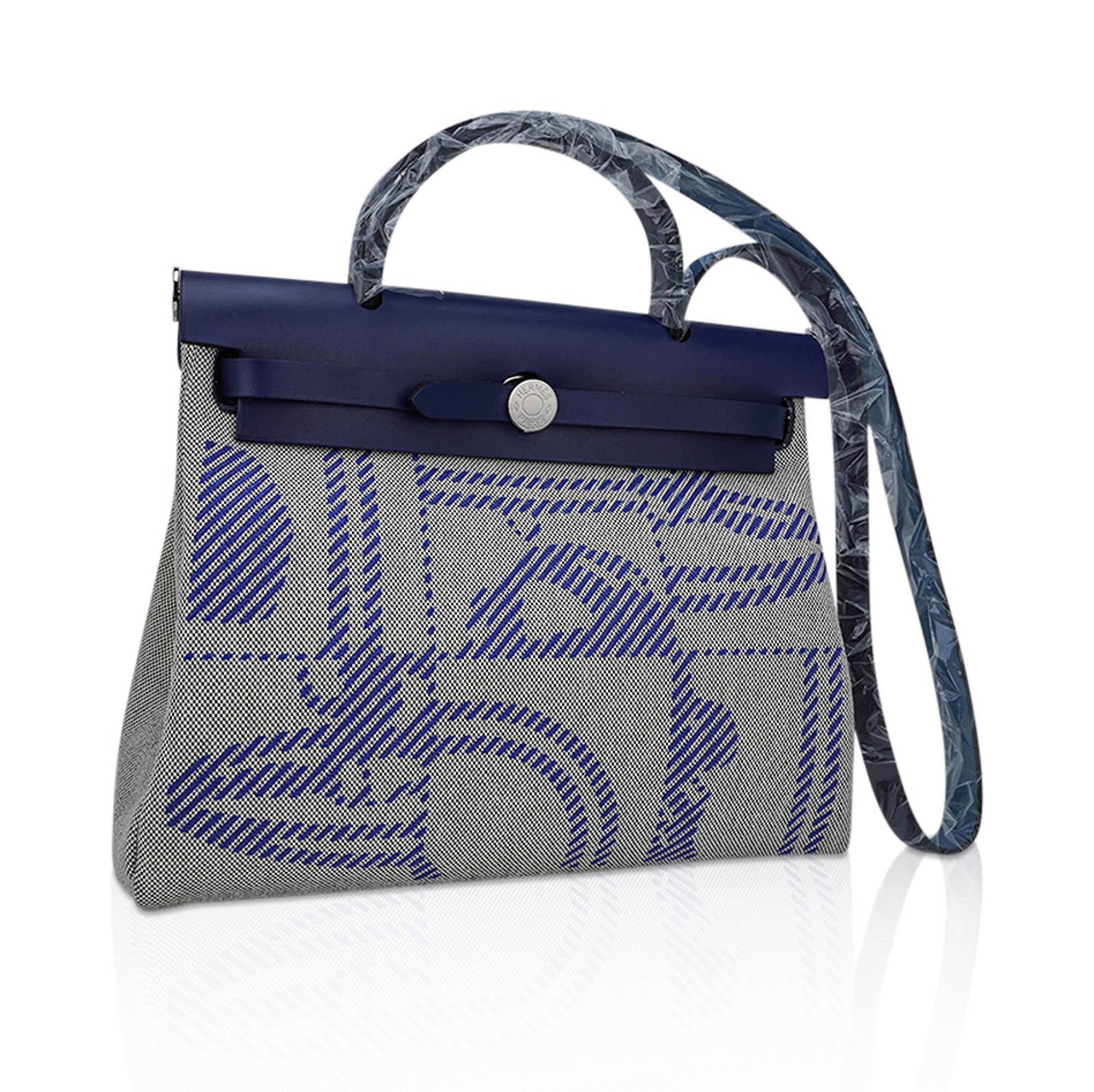 Mightychic offers an Hermes Herbag Zip Retourne 31 featured in Bleu Saphir Vache Hunter leather.
Toile H Brides de Gala en Desodre in Bleu De France, Ecru and Black colorway.
This pattern is deisgned by Hugo Grygkar and Cyrille Diatkine.
The bag has