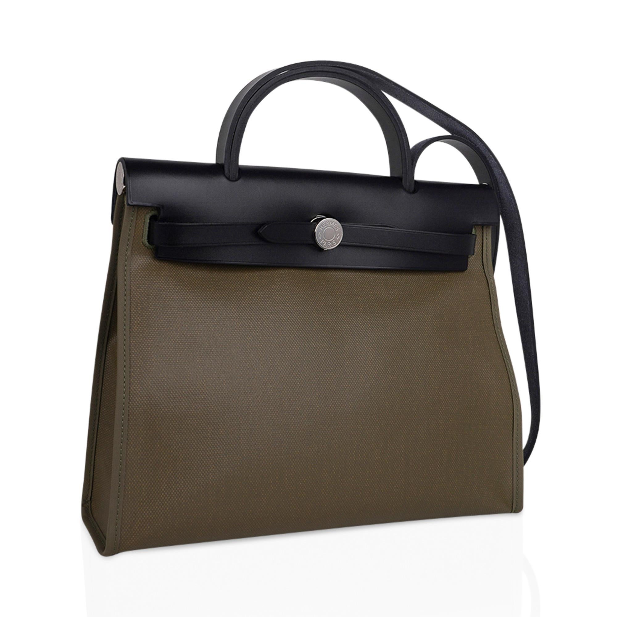 Mightychic offers an Hermes Herbag Zip 31 featured in Khaki Berline, a coated canvas and Black leather.
Signature Herbag Clou de Selle in Palladium hardware.
Bag has Toile removable pochette.
Comes with lock, keys and clochette, sleeper and