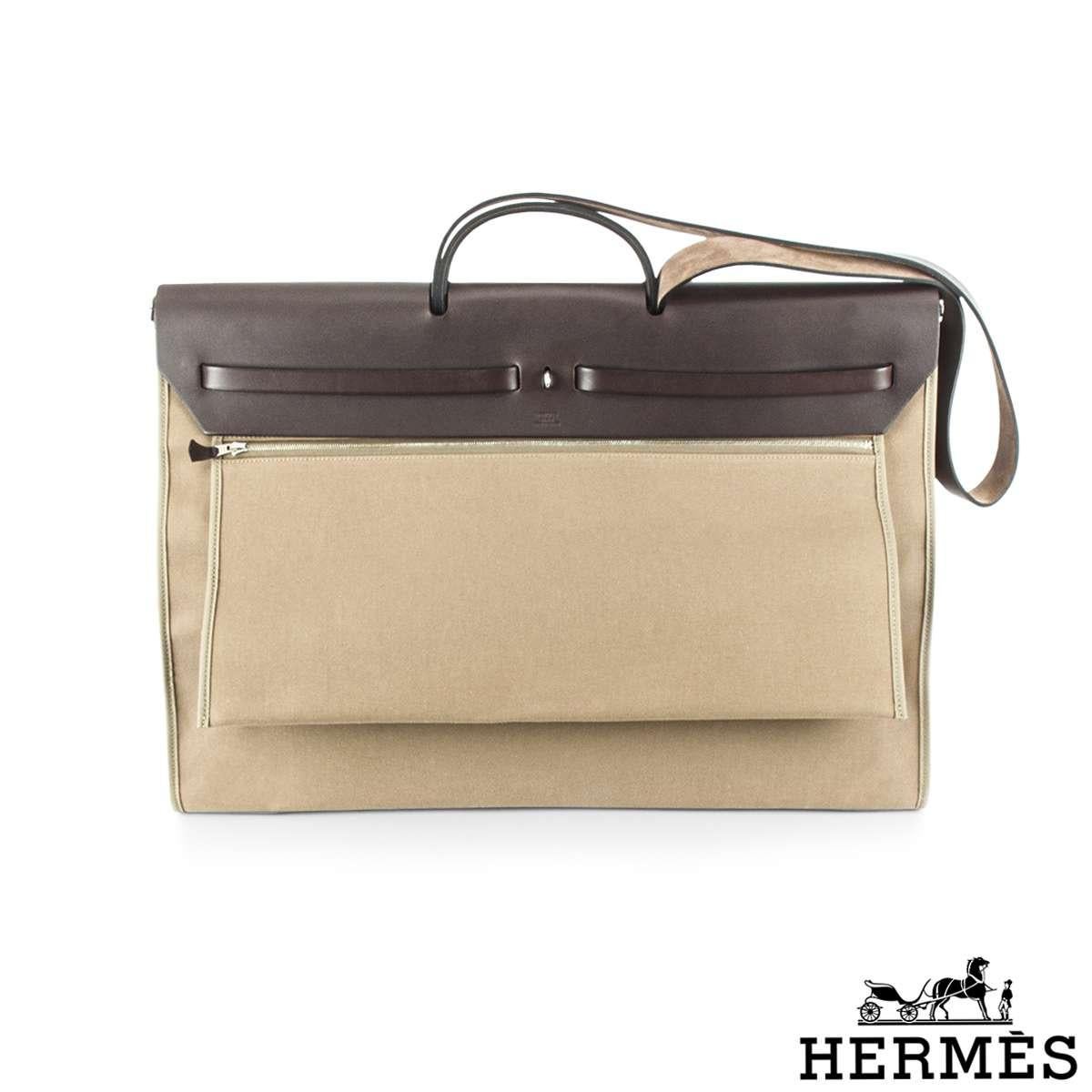 A chic and stylish Hermes Herbag Zip. The exterior of this Herbag features a top handle with a crossbody strap in Ebene Vache Hunter leather on the top section whereas the body of the bag is made out of canvas, has a Clou de Selle closure and is