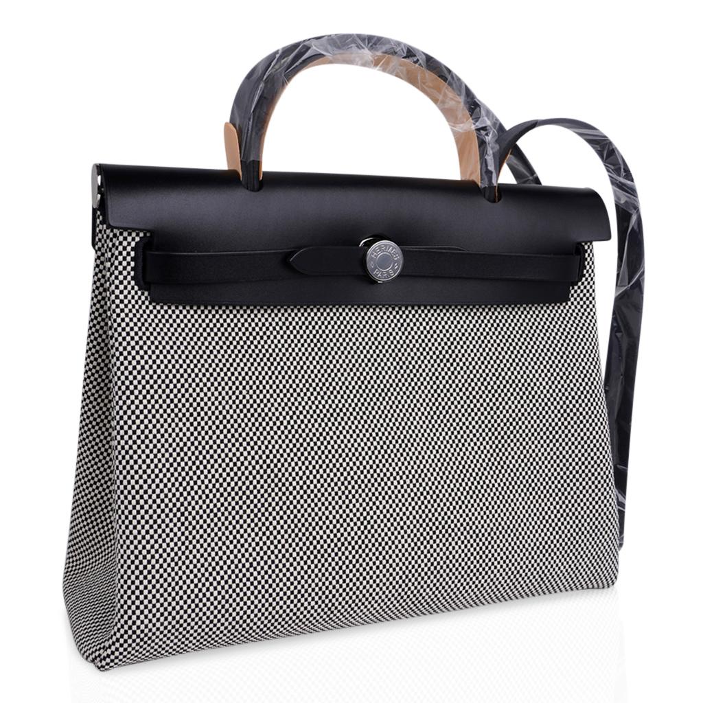 Mightychic offers an Hermes Herbag Zip 31 featured in crisp Black and White H Toile and Black Vache Hunter cowhide leather.
Signature Clou de Selle closure.
Rear has an exterior Black canvas zip pocket.
Interior has a matching removable