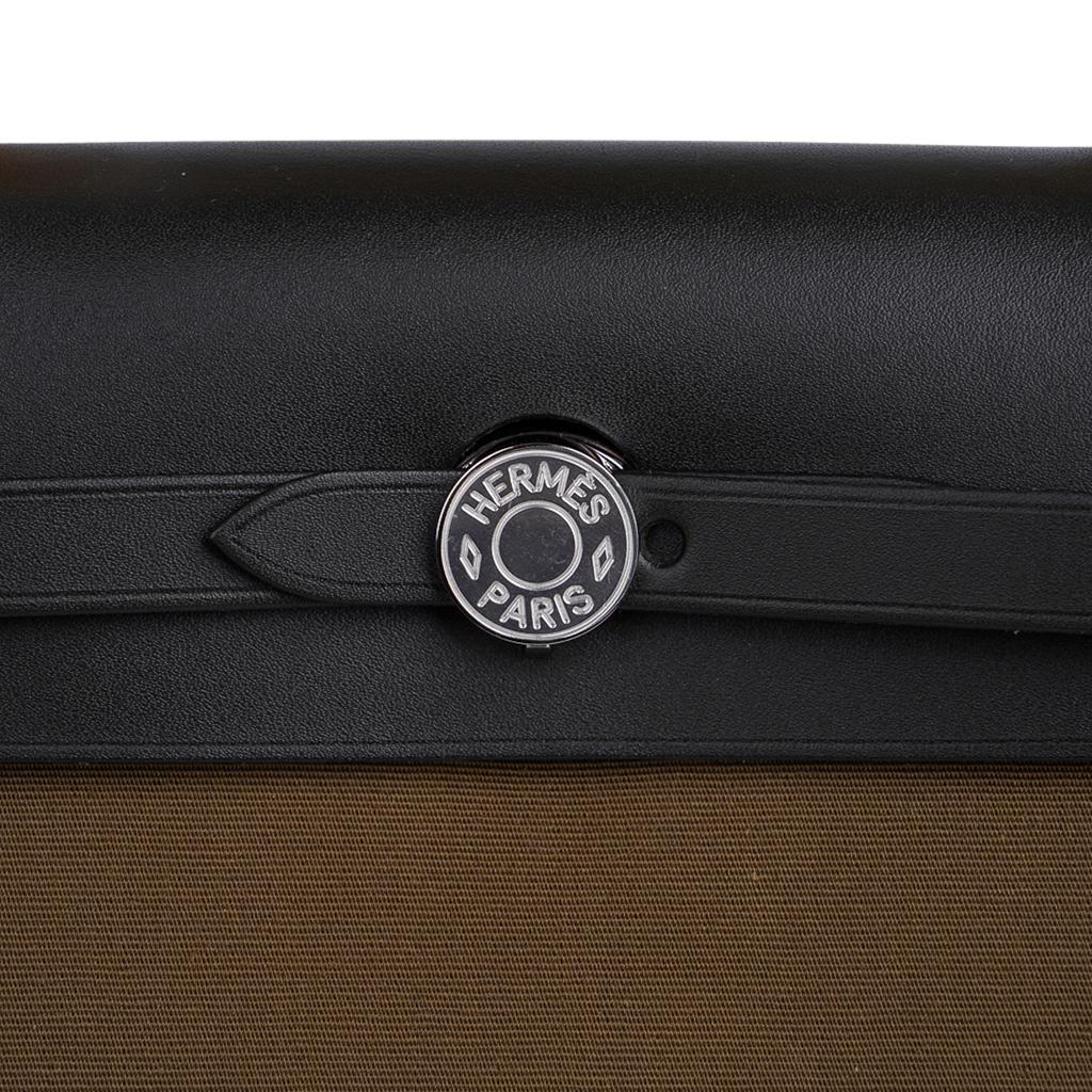 Guaranteed authentic Hermes Herbag Zip 31 featured in Vert Olive Officier canvas and Black Vache Hunter cowhide leather.
Signature Clou de Selle closure.
Rear has an exterior canvas zip pocket.
Interior is Vert Olive canvas and has a matching