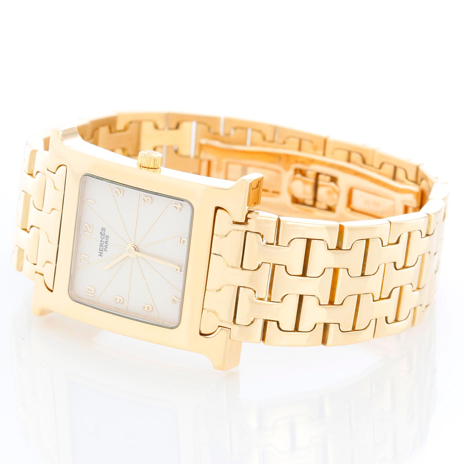 Hermes Heure H 18k Yellow Gold Ladies Watch HH1-585 - Quartz. 18K Yellow gold (26 mm x 35 mm ). White with Arabic numerals, sapphire crystal. 18K Yellow gold bracelet; will fit up to a 7 inch wrist . Pre-owned with custom box.