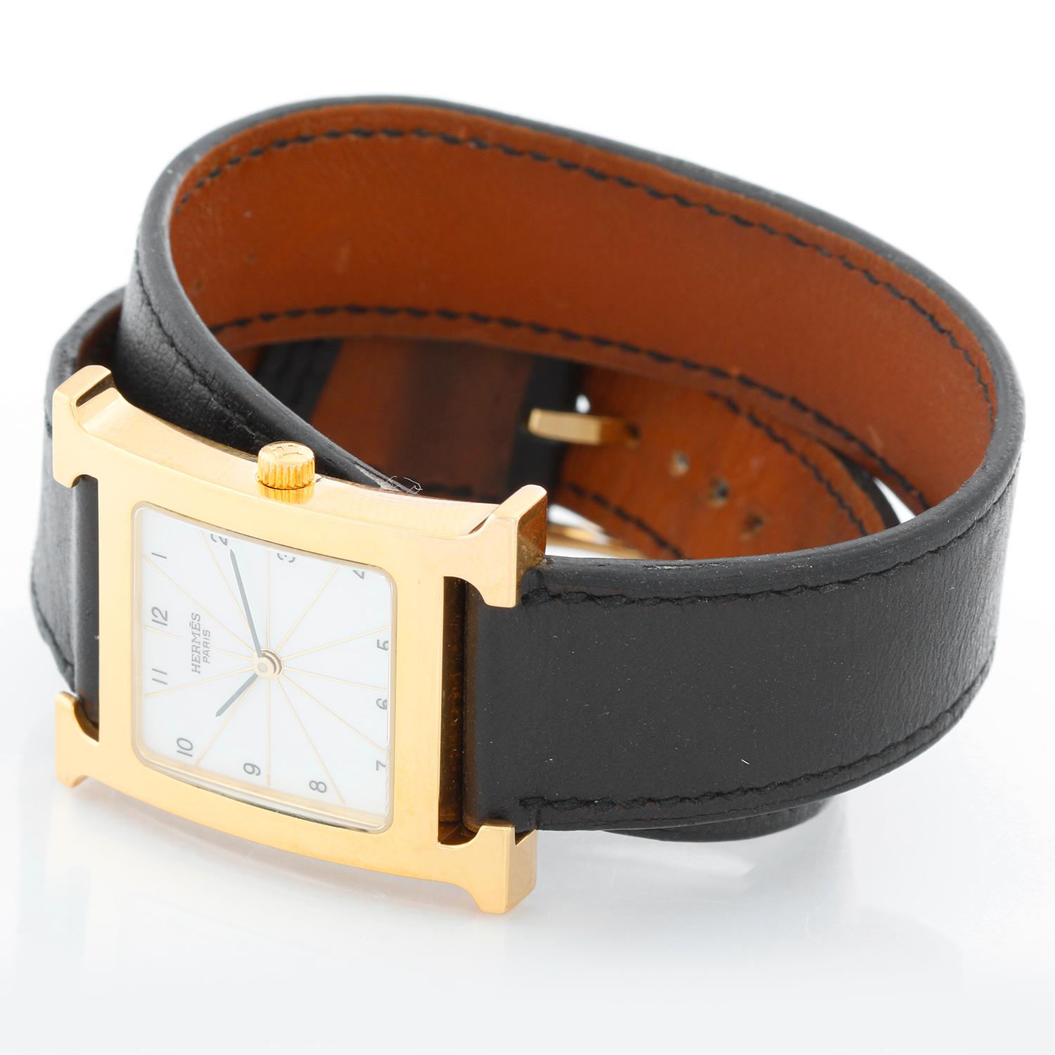 Hermes Heure H 18k Yellow Gold-Plated  Ladies Watch, HH1.501 - Quartz. Case is stainless steel, 18k yellow gold-plated (30mm x 35mm). Dial is  gloss white with Arabic numerals, sapphire crystal. Double leather strap with tangle buckle . Pre-owned
