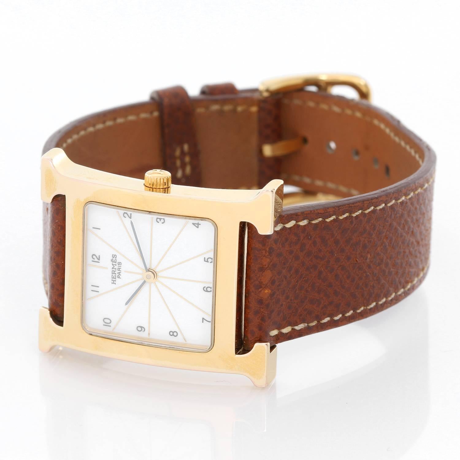 Hermes Heure H 18k Yellow Gold-Plated  Ladies Watch, HH1.501 -  Quartz. Case is stainless steel, 18k yellow gold-plated (30mm x 35mm). Dial is  gloss white with Arabic numerals, sapphire crystal. Brown leather strap band with Tang buckle (18k