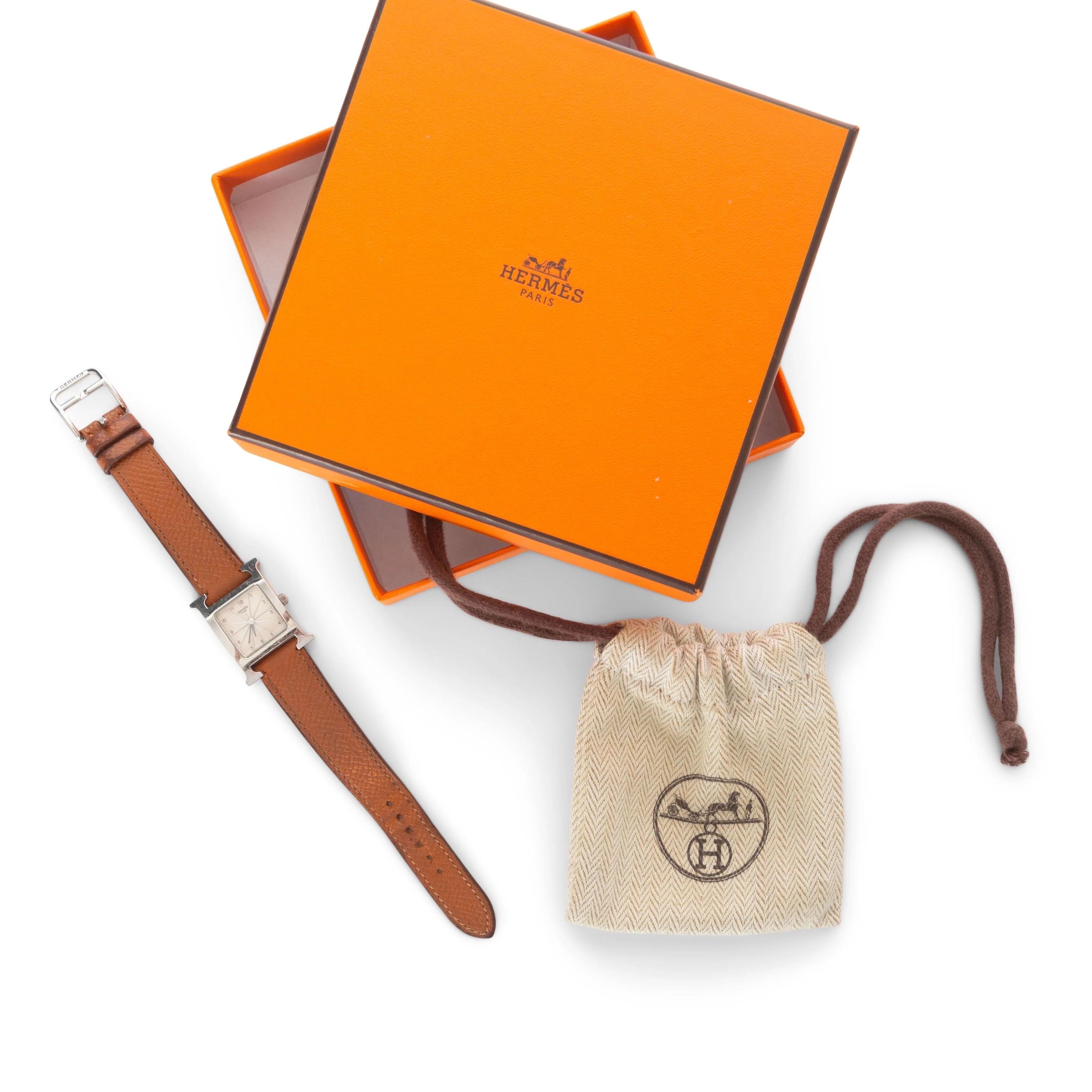 Hermès Heure H Mini Model 21mm Steel and Brown Leather Watch

Model HH1.210
Signature “H” frame
Stainless steel hardware
White face
Brown leather strap
Quartz movement
Made in Switzerland
Very good preowned condition; moderately worn with light