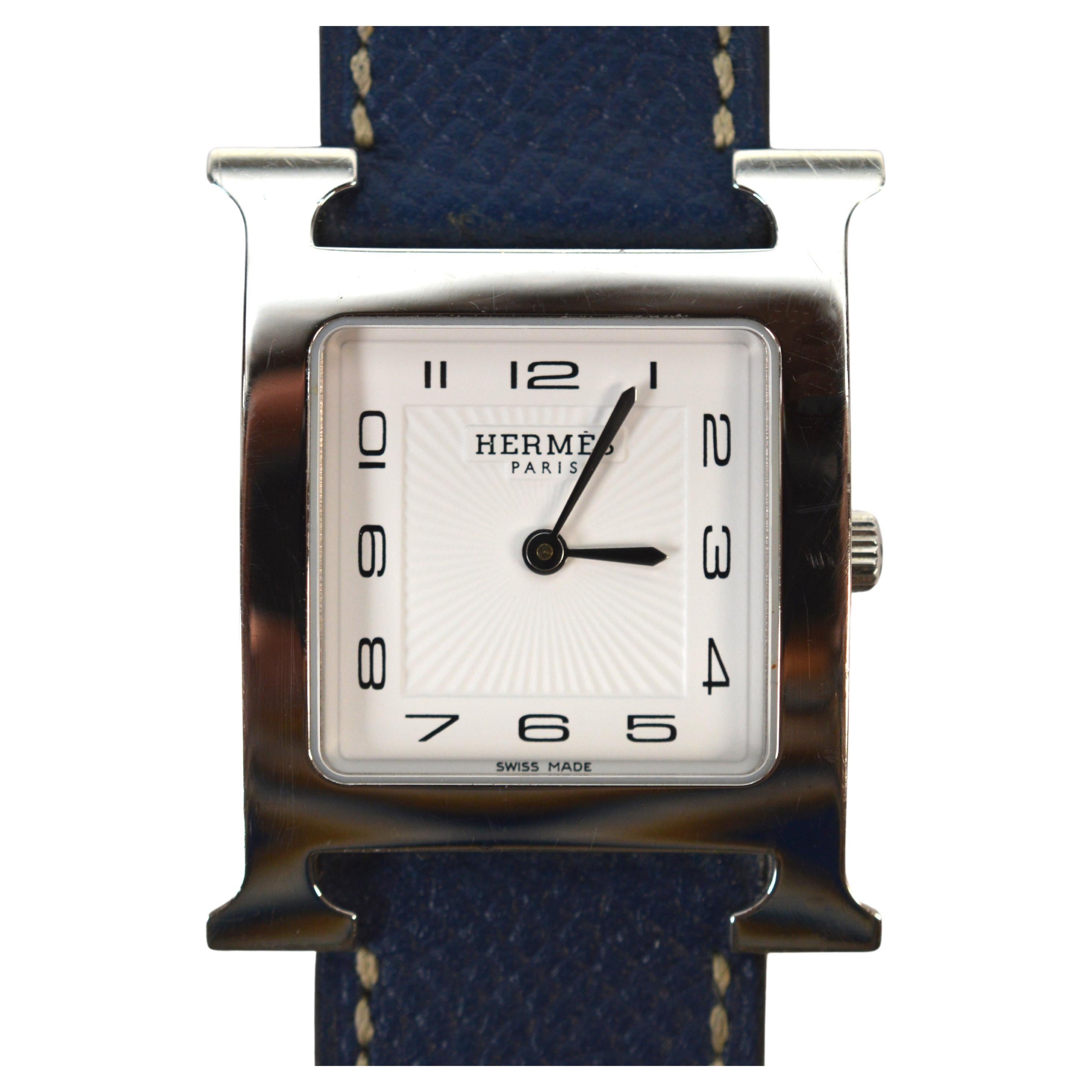 A sleek classic by Hermes. The H collection, introduced in the mid-nineties is ever popular today. Powered by a quartz movement, this Hermes Heure H , model HH1.510e has a smooth stainless steel square case with a measurement of 26mm and is