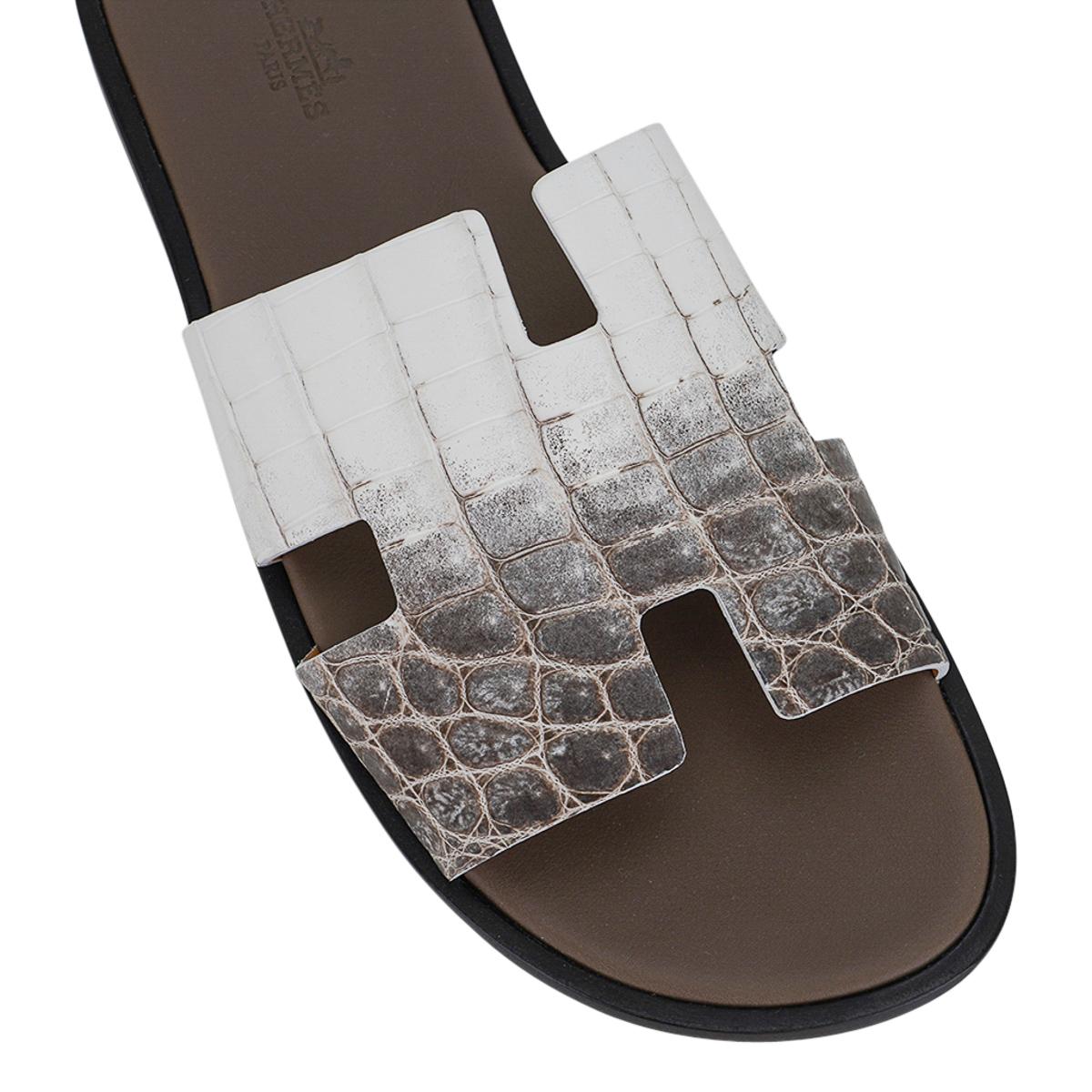 Mightychic offers a pair of Hermes Men's Izmir sandal featured in Himalaya Blanc Crocodile.
The iconic H cutout over the top of the foot in Swift leather.
Sophisticated in a silhouette that works for every wardrobe.
Insole is Taupe leather.
Wood
