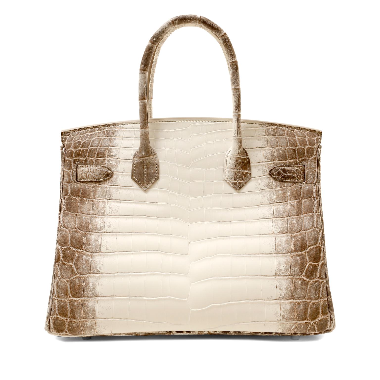 This authentic Hermès 30cm Himalayan Crocodile Birkin is in pristine unworn condition with the protective plastic intact on the hardware, 2021 collection.  Possibly considered the most rare of all Hermès bags, Hermès may no longer  be producing the