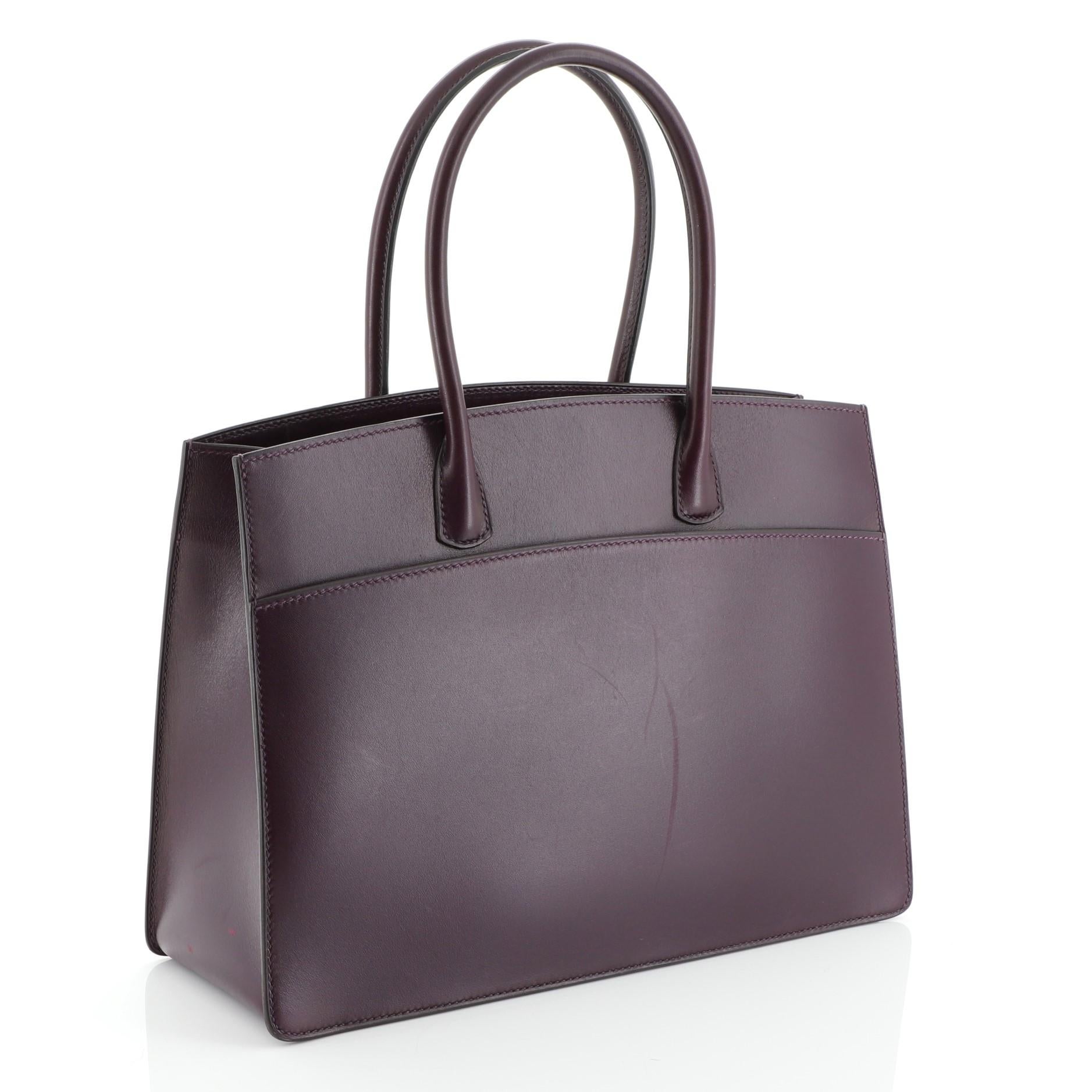 This Hermes Horizontal White Bus Handbag Leather 30, crafted in Raisin purple Box Calf leather, features dual rolled handles and gold hardware. It opens to a Raisin purple Chevre leather interior. Date stamp reads: F Square (2002). These are