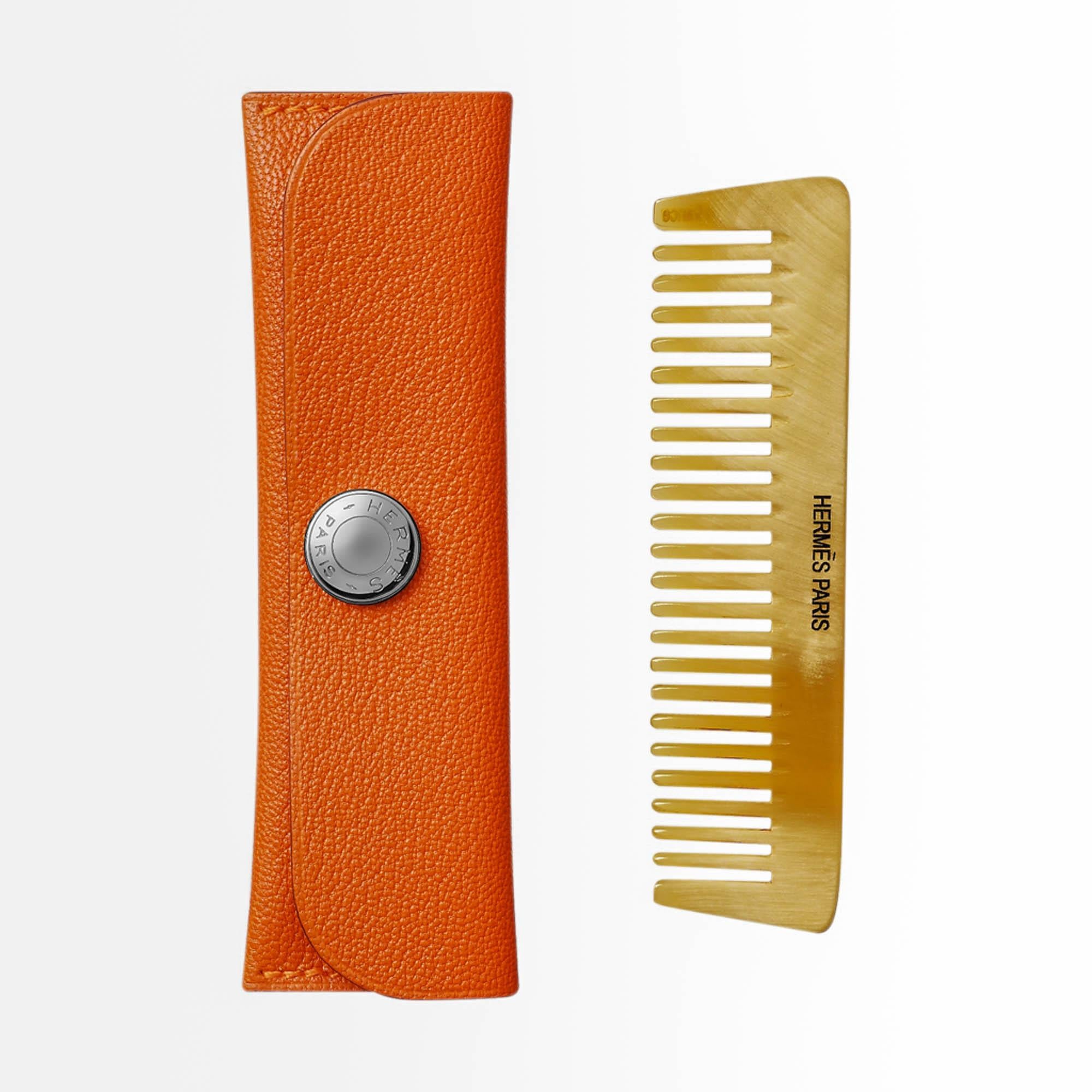 Hermes small comb featured in Horn with Hermes Paris engraving.
Hermes Orange Swift leather case has Clou de Selle snap.
Perfect size to fit any size bag, a pocket - perfect to be coiffed on the go!
New or Store Fresh Condition.
final sale

CASE