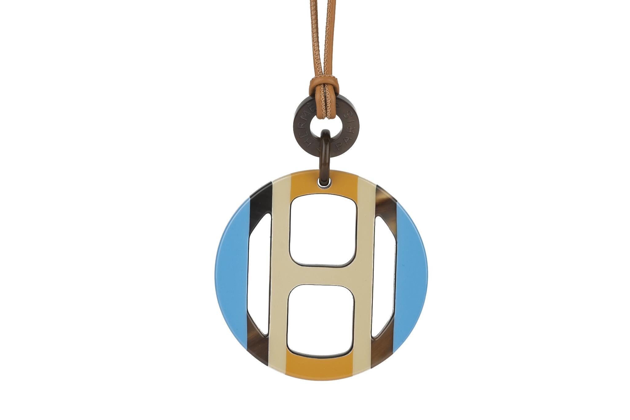 Le collier à pendentif H d'Hermès est à la fois chic et décontracté. Fabriqué en corne, cuir, cordon et quincaillerie en palladium. La chute du cordon est de 15