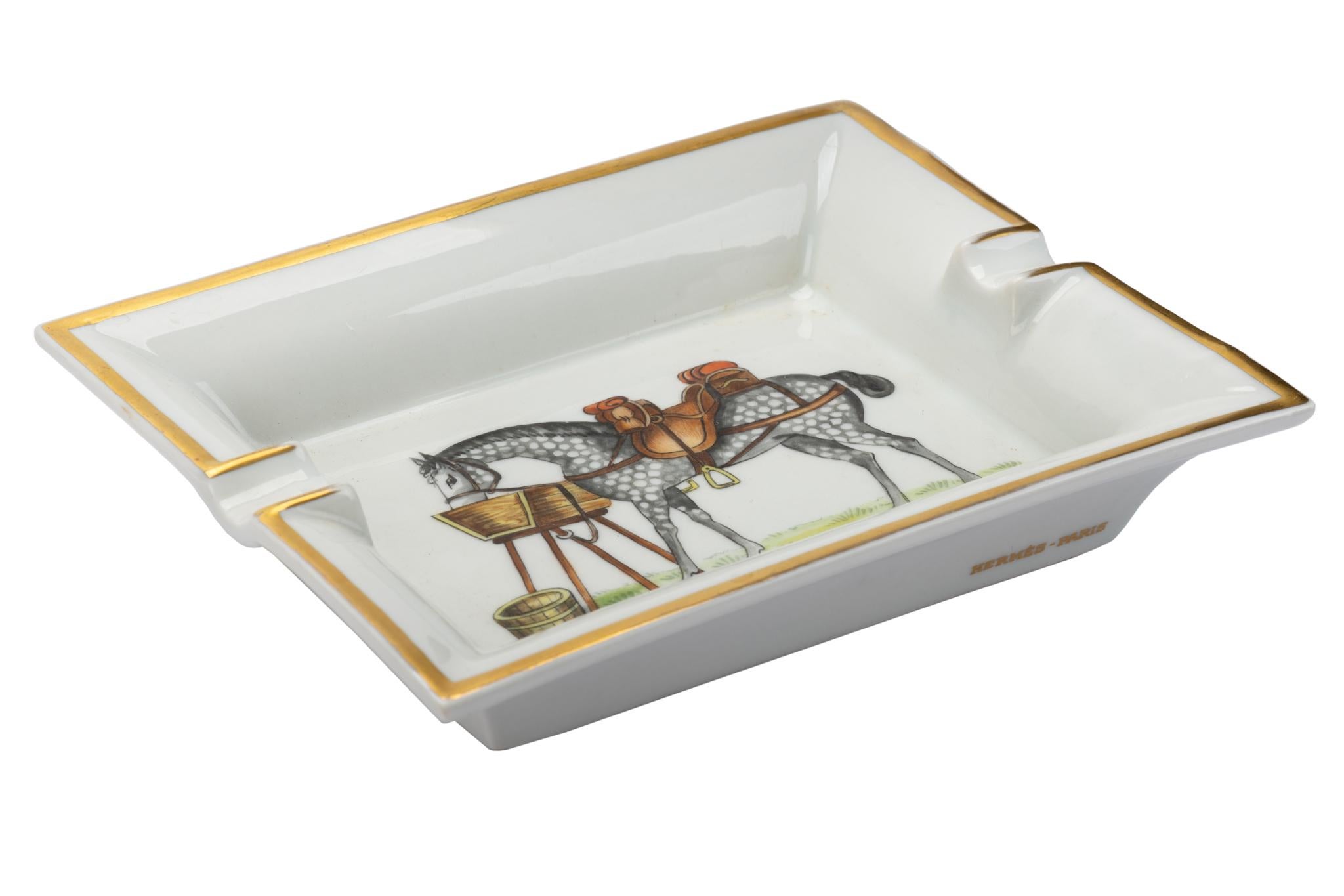 Hermes signature ashtray with horse design in white and gold. Suede stamped bottom. Minor wear on it. Made in France.