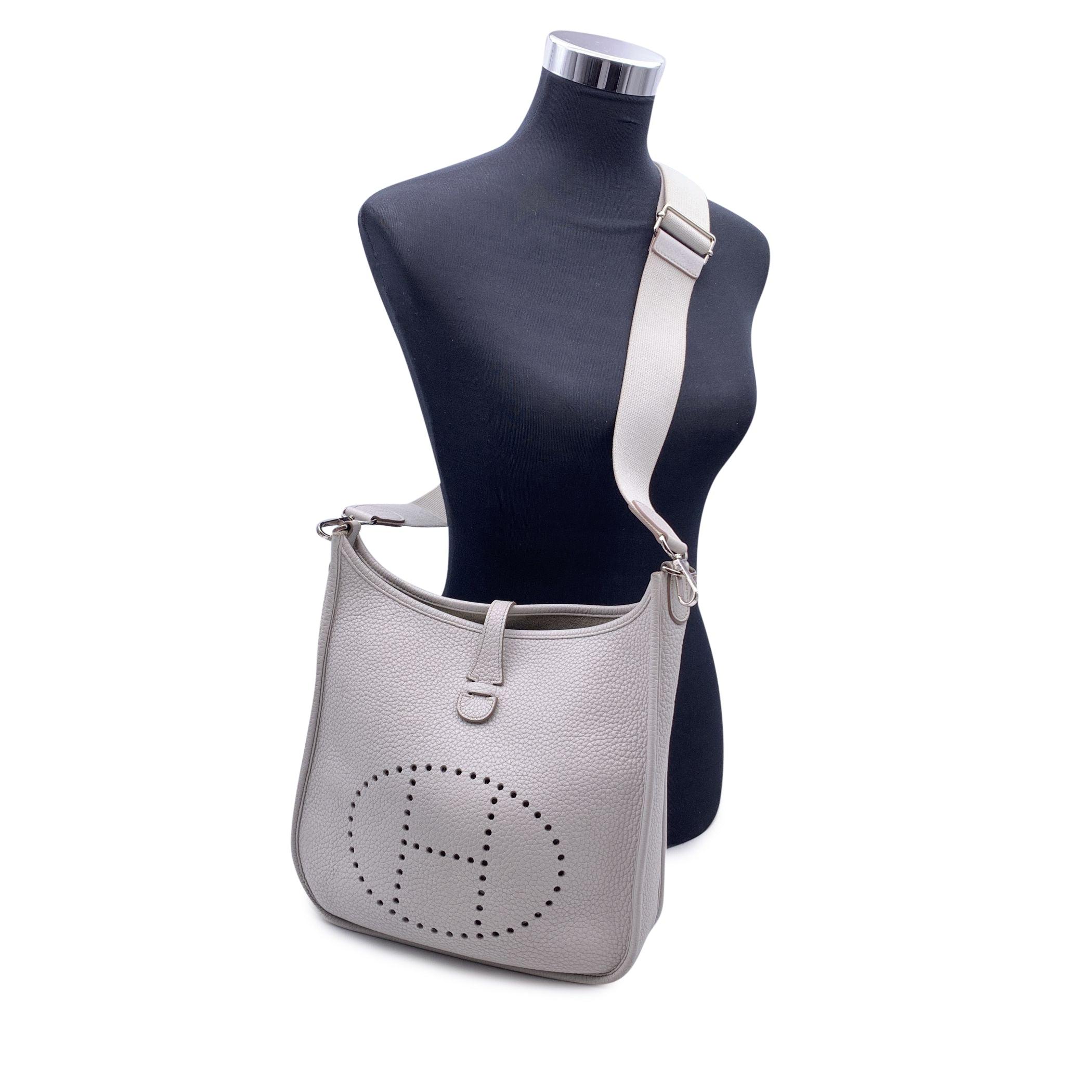This beautiful Bag will come with a Certificate of Authenticity provided by Entrupy. The certificate will be provided at no further cost. Hermes 'Evelyne III PM' shoulder bag in ice grey Taurillon Clemence leather. Designed by Evelyne Bertrand in