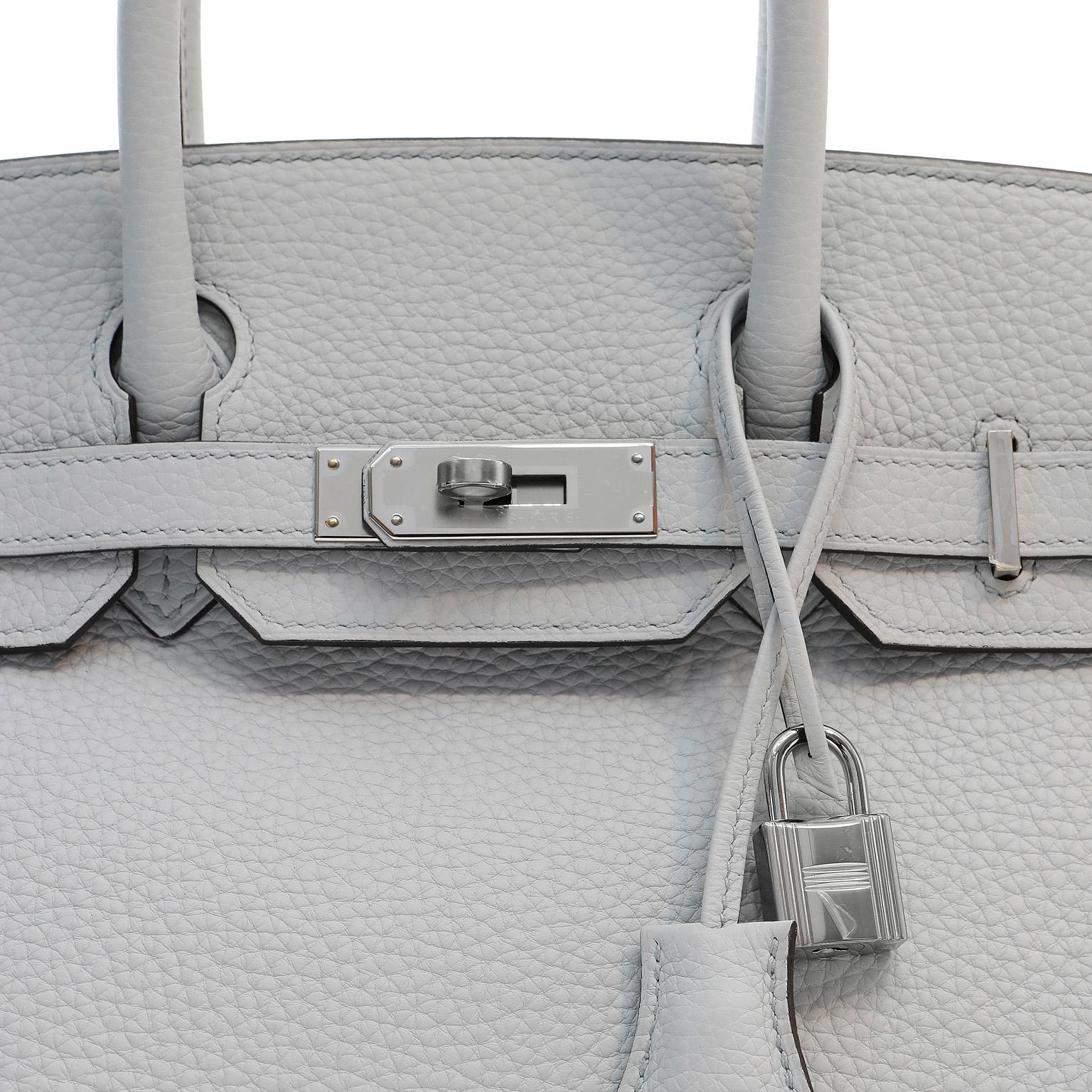 This authentic Hermès Icy Grey Togo Leather 30 cm Birkin Bag is in pristine unworn condition.  A soft neutral shade that appears pale blue or grey in different lighting, it can be enjoyed throughout all seasons. 

Togo is scratch resistant calf