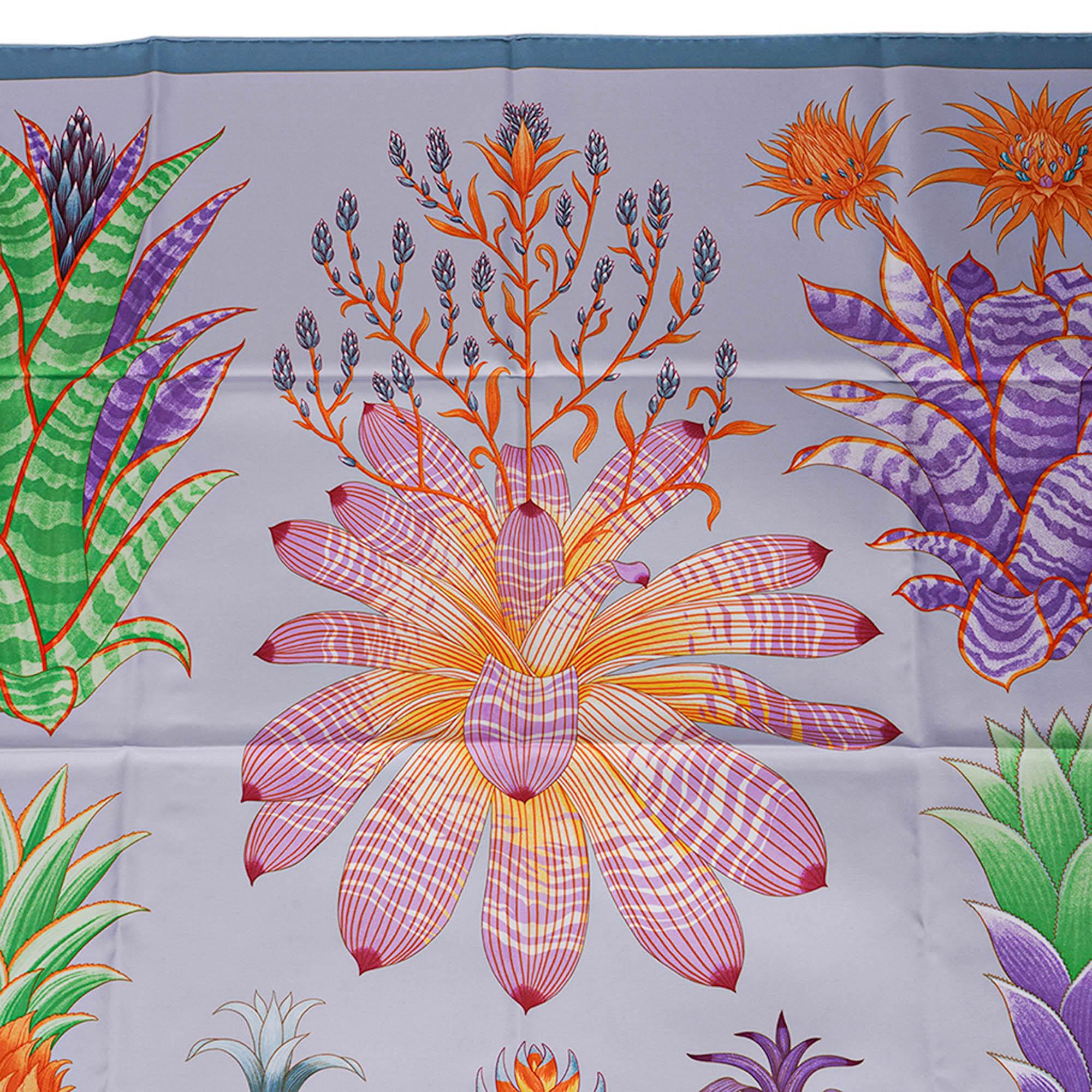Mightychic offers an Hermes Index Bromeliaceae Silk Twill scarf featured in Bleu Ciel and Violet.
Designed by Katie Scott, the scarf illustrates eight species of bromeliads from the tropical and sub tropical regions of America.
Hand rolled