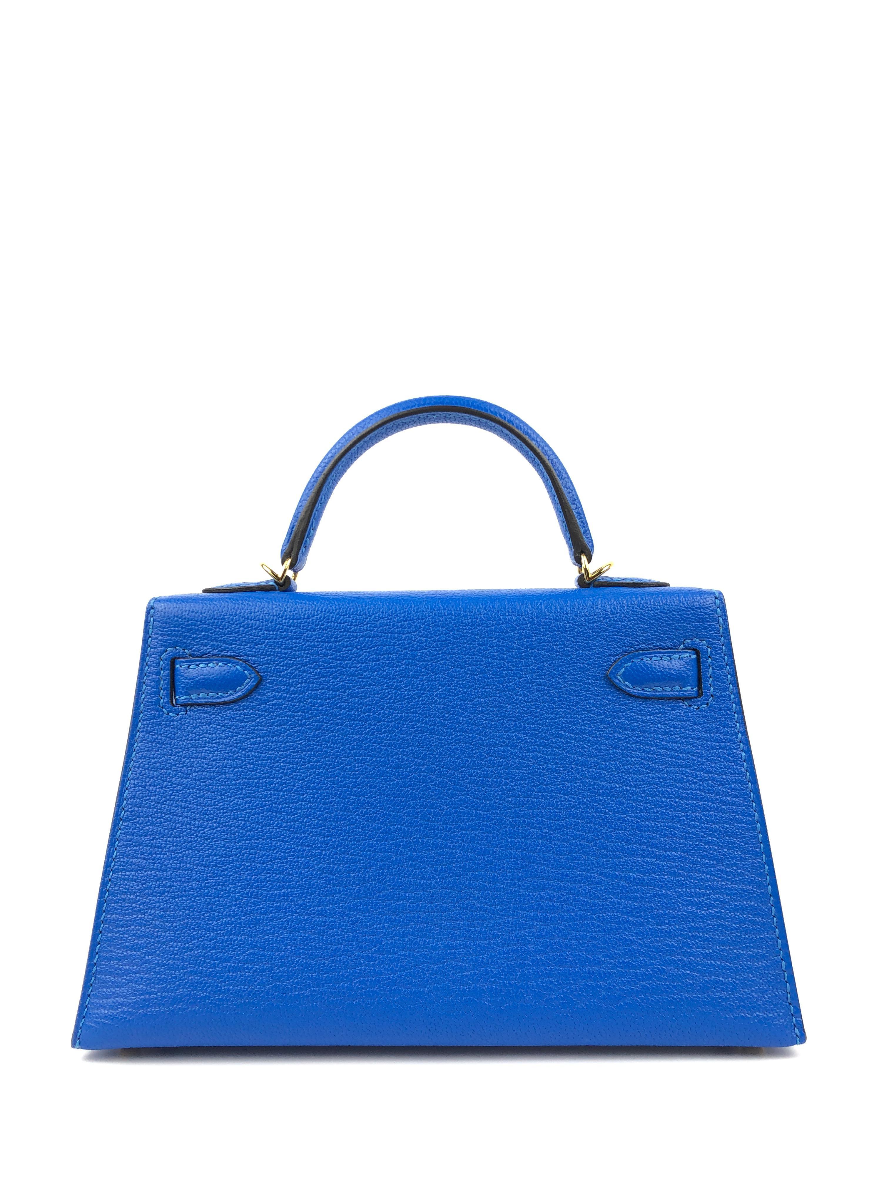This authentic Hermès Intense Blue Chevre 20 cm Mini Kelly is pristine with the protective plastic intact on the hardware.  Petite and feminine, the crossbody Kelly is very rare in the 20 cm silhouette.
Intense blue chevre leather is extremely