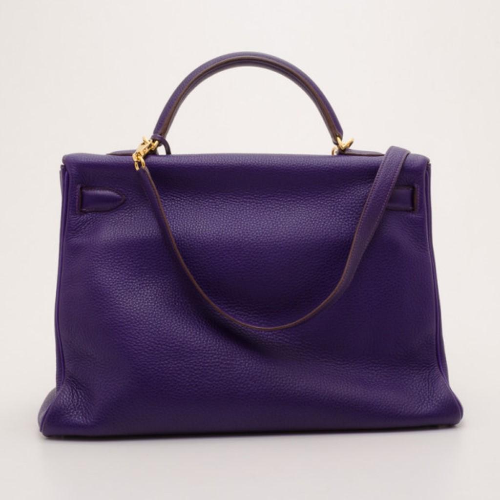 The famous Kelly by Hermes is a handbag that will remain a must-have bag for years to come. This version is crafted from supple Togo leather in purple iris. The classic exterior is detailed with a gold twist lock closure, a leather clochette, double