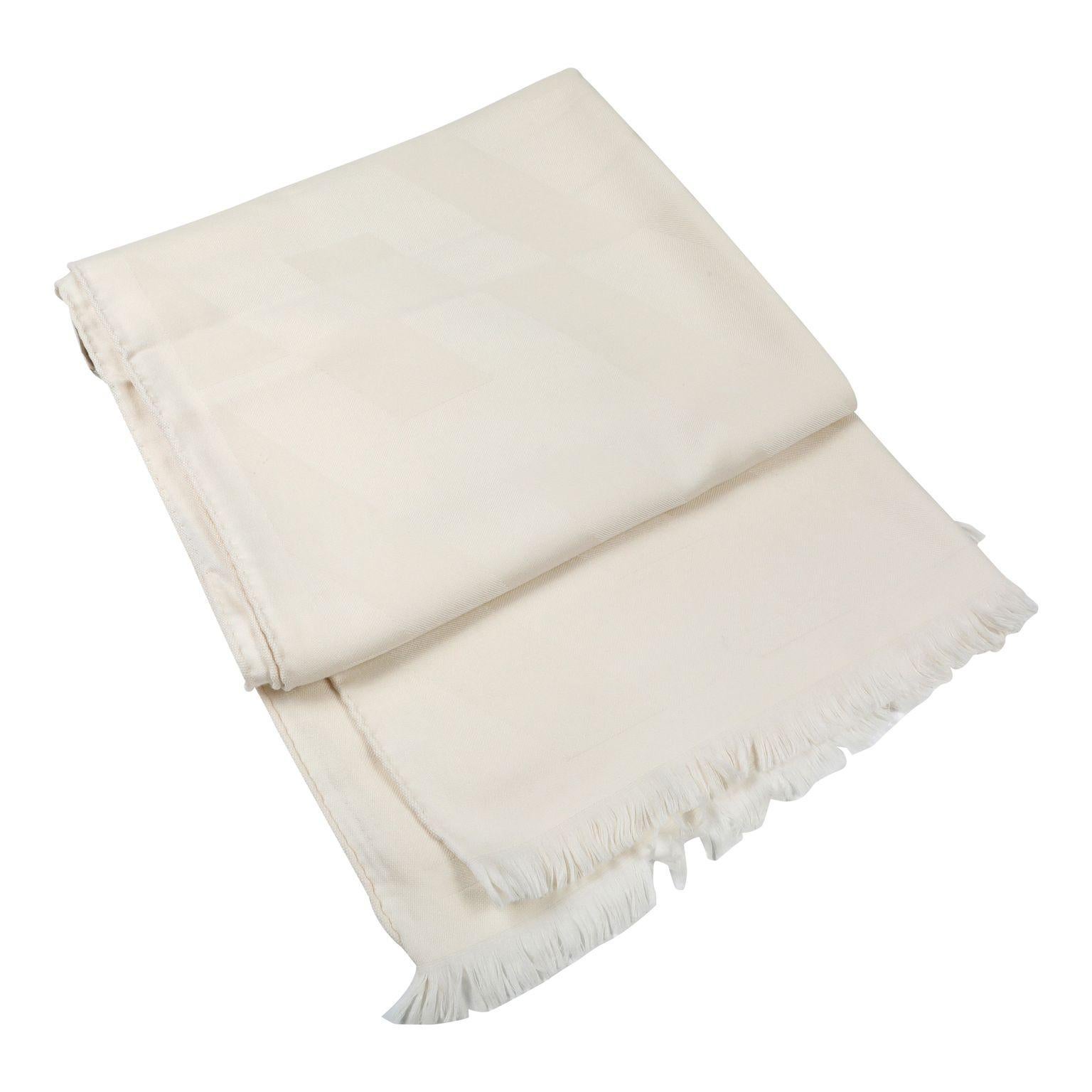 This authentic Hermès Ivory Cashmere H Scarf is pristine.  Plush ivory cashmere, fringed edges.  

ACO 13831

