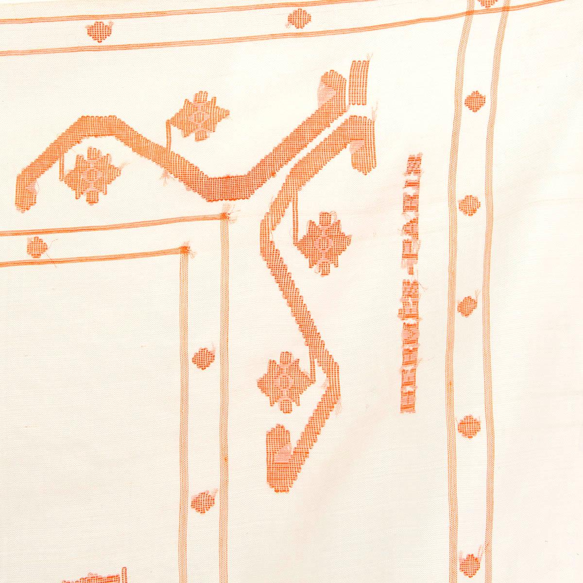 100% authentic Hermès fringed scarf in ivory and orange cotton voile (50%), silk (40%) and viscose (10%) with detail in orange. Handwoven in India. Has been worn and is in excellent condition. 

Measurements
Width	90cm (35.1in)
Length	200cm
